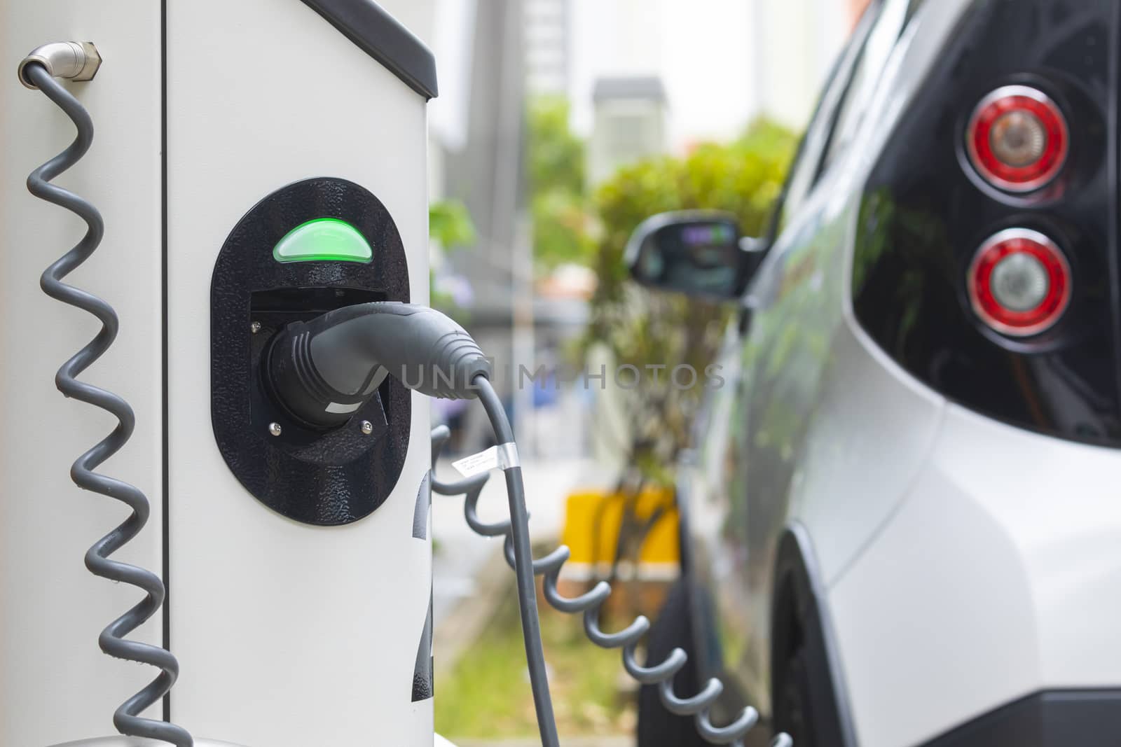 Electric car charging station at street level in Singapore, Southeast Asia.