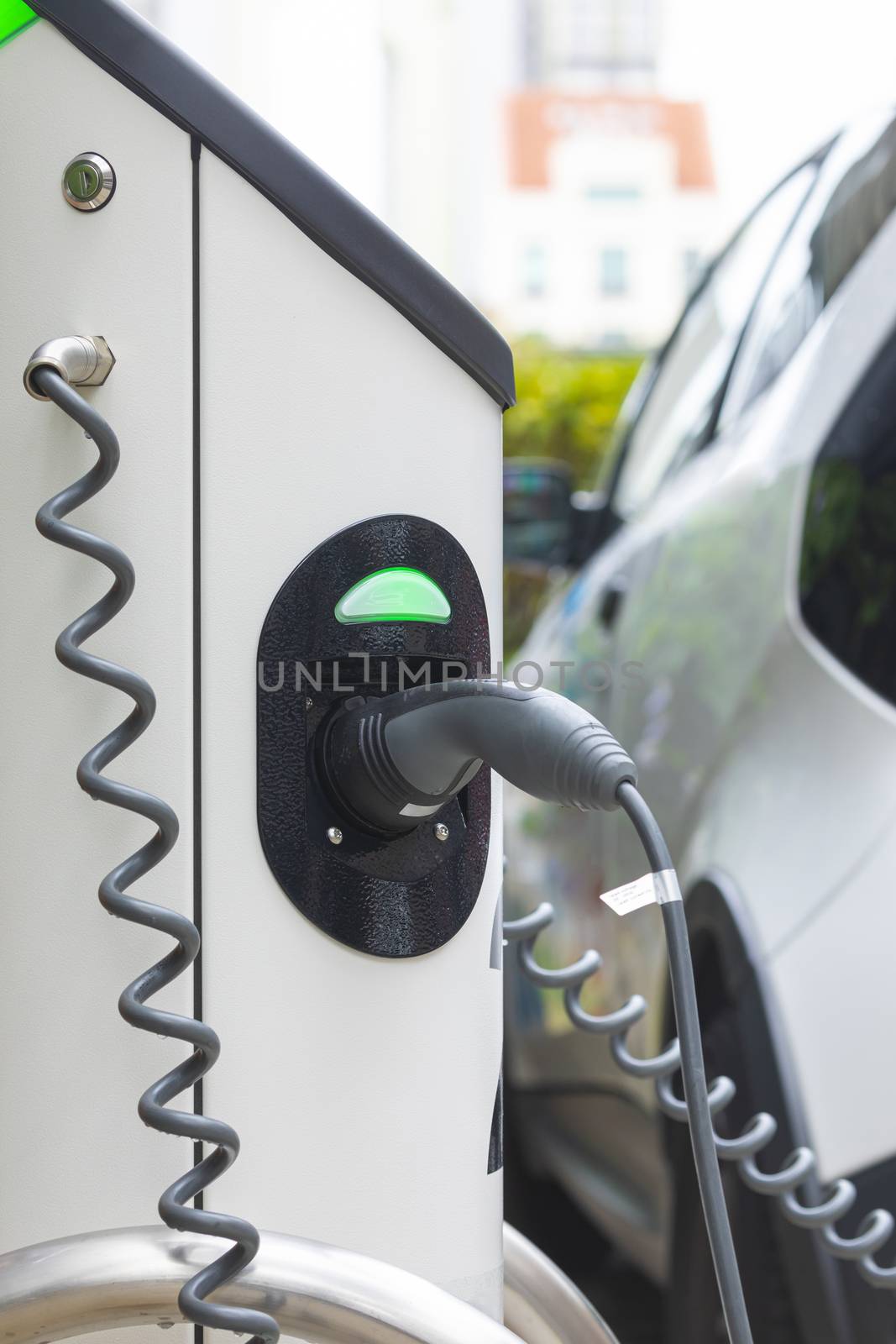 Electric car charging station at street level in Singapore, Southeast Asia. by alvarobueno