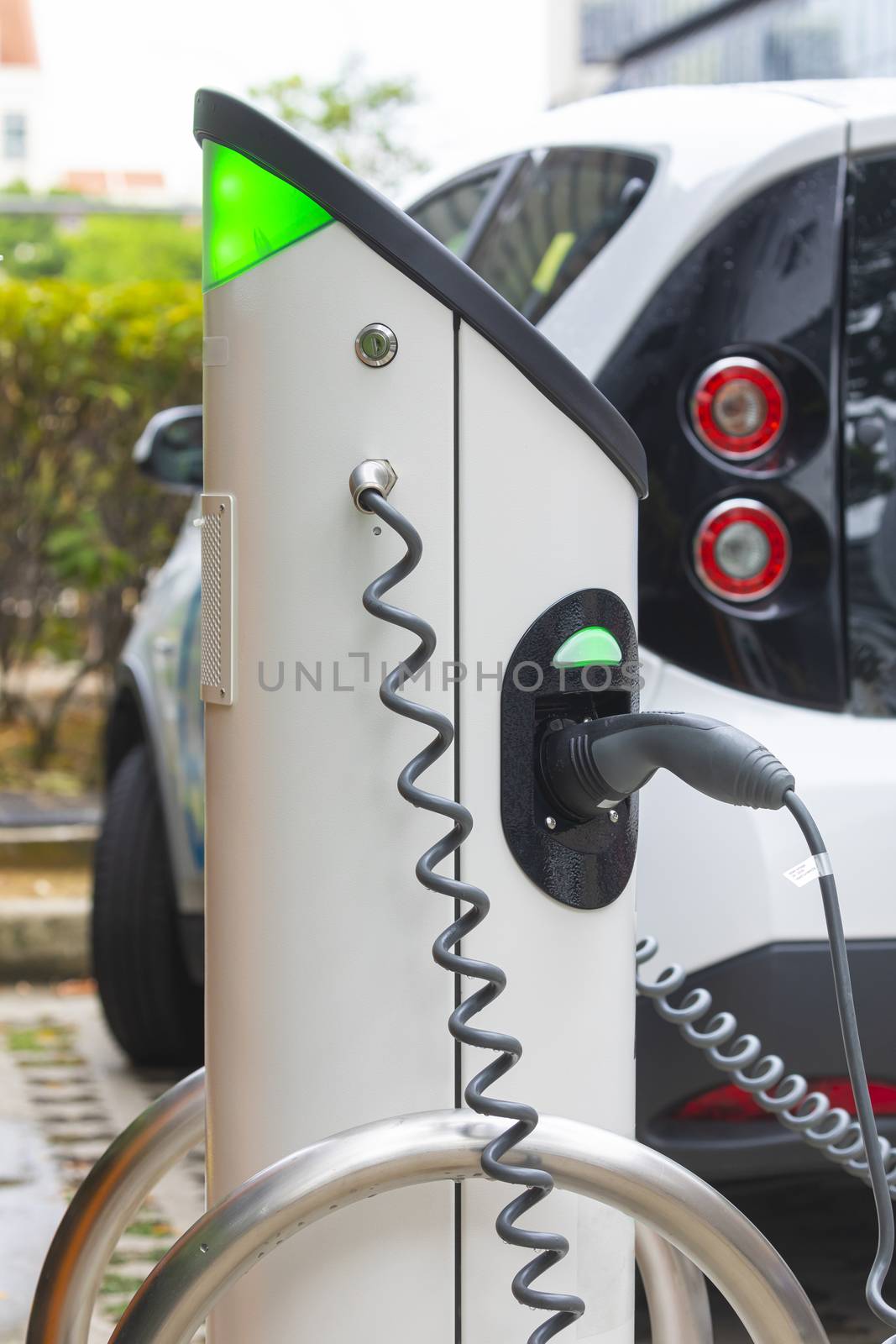 Electric car charging station at street level in Singapore, Southeast Asia. by alvarobueno