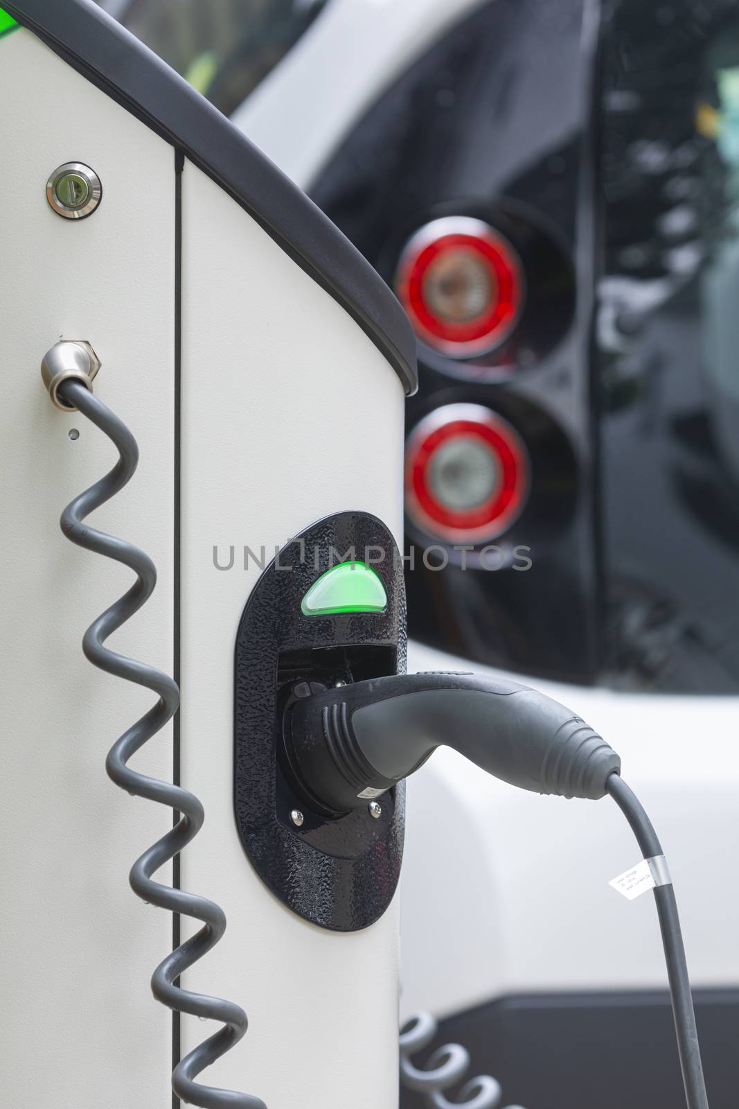 Electric car charging station at street level in Singapore, Southeast Asia. by alvarobueno