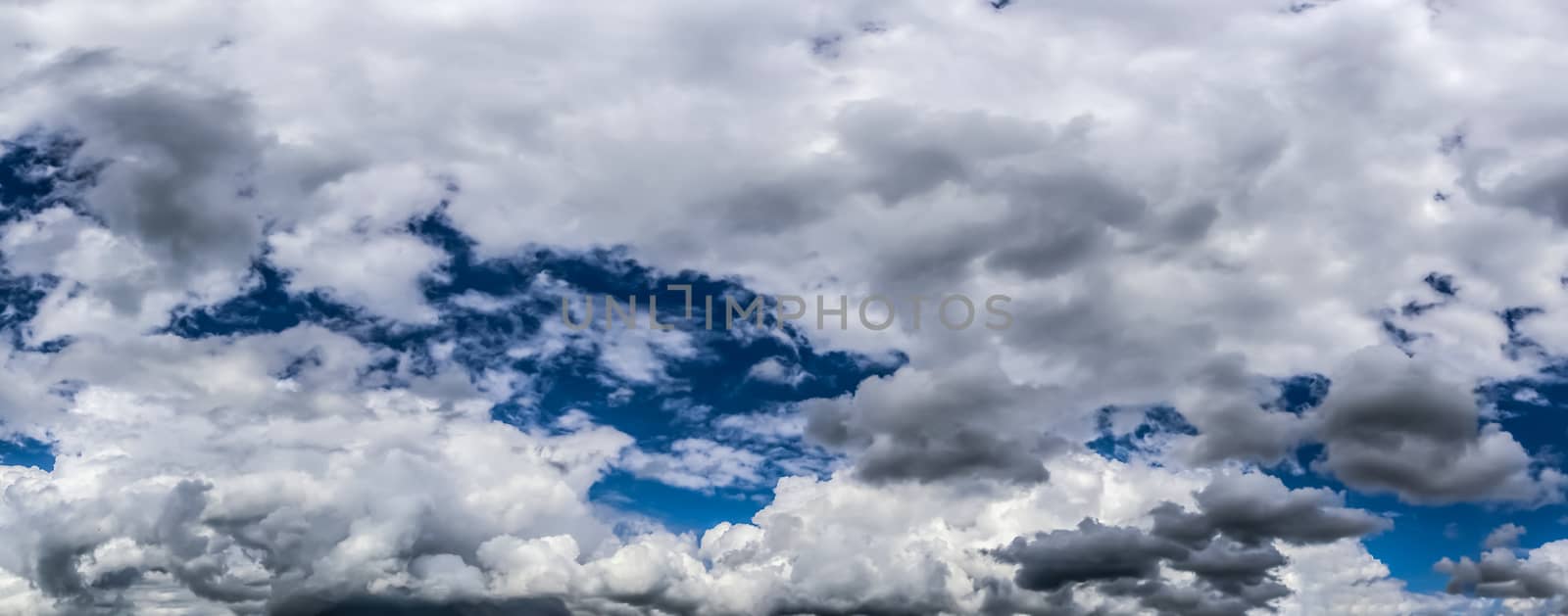Beautiful fluffy white cloud formations in a deep blue summer sk by MP_foto71