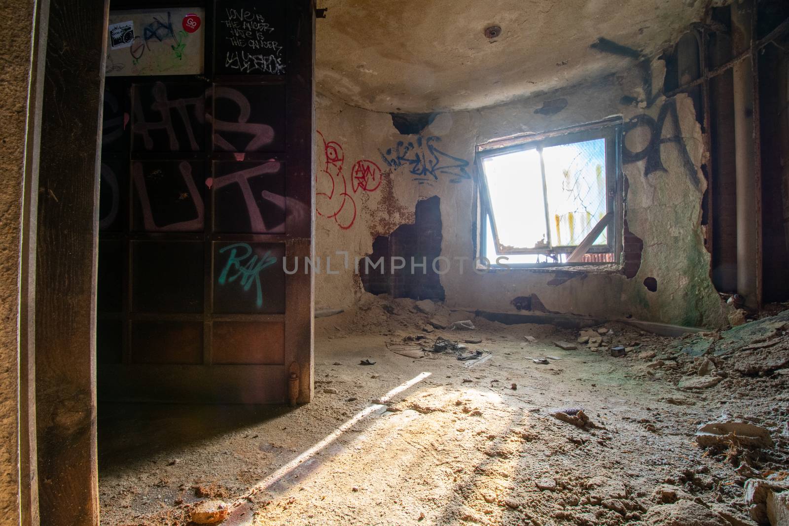A Small Room in an Abandoned Building Covered in Graffiti by bju12290