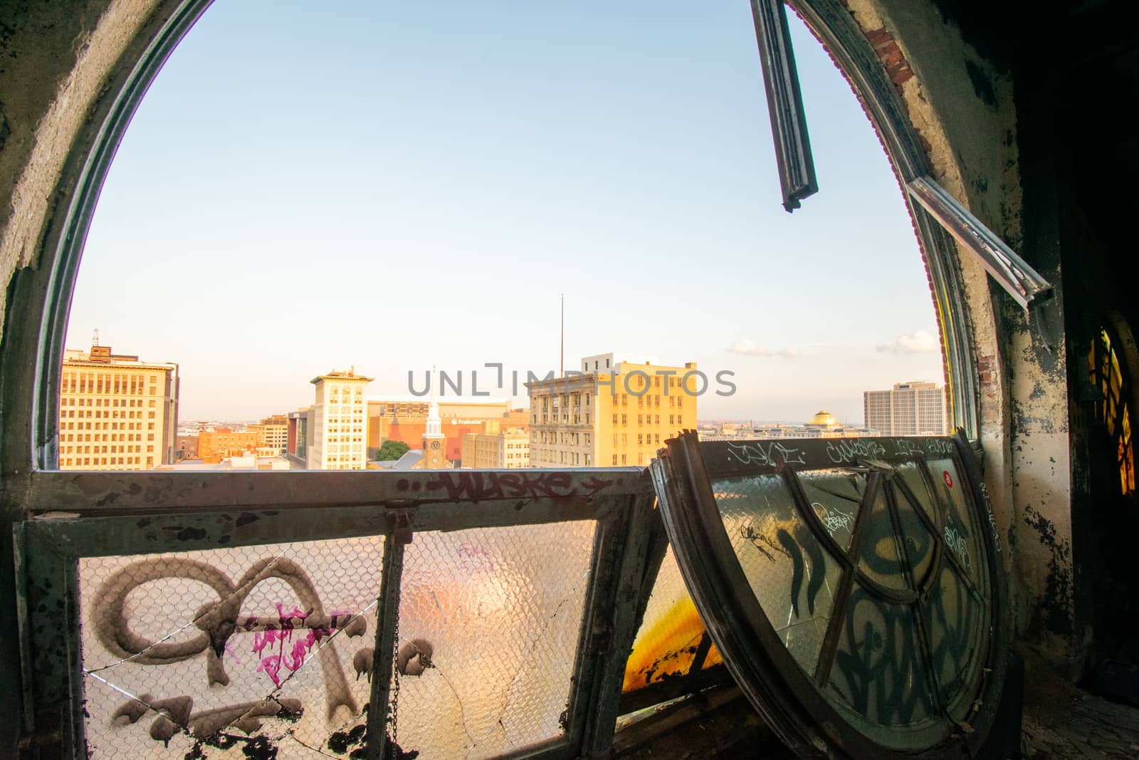 Looking Out a Large and Broken Arched Window at a City Skyline i by bju12290