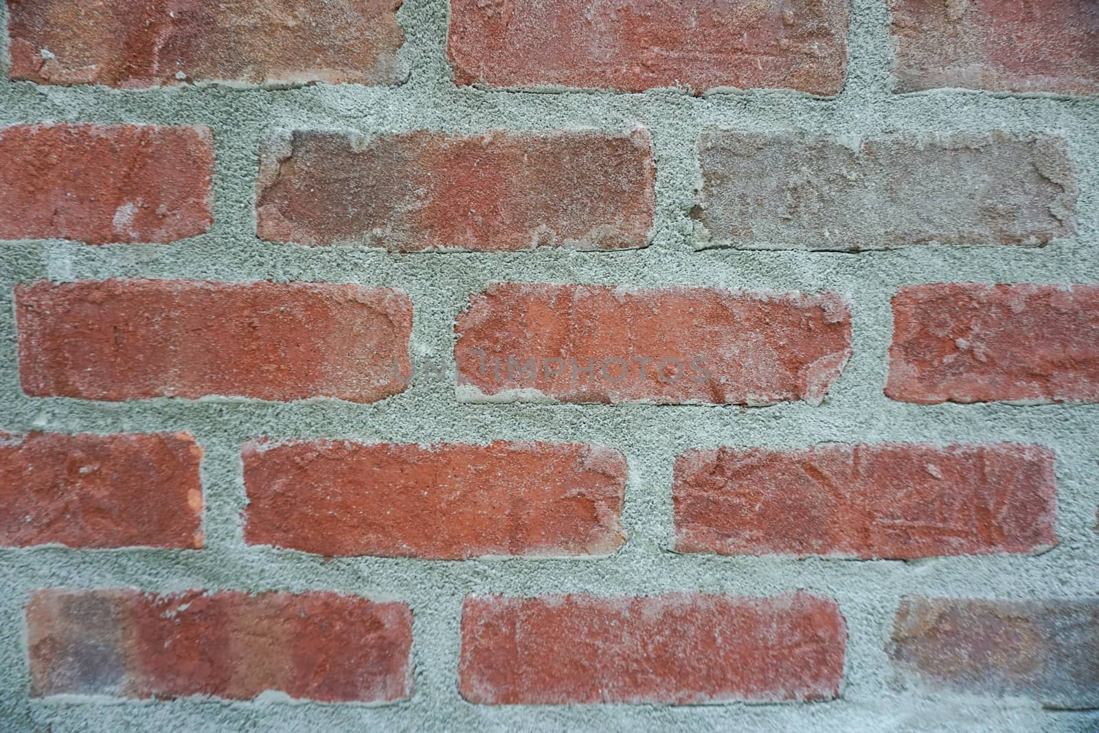 Brown brick wall with grungy grey cement