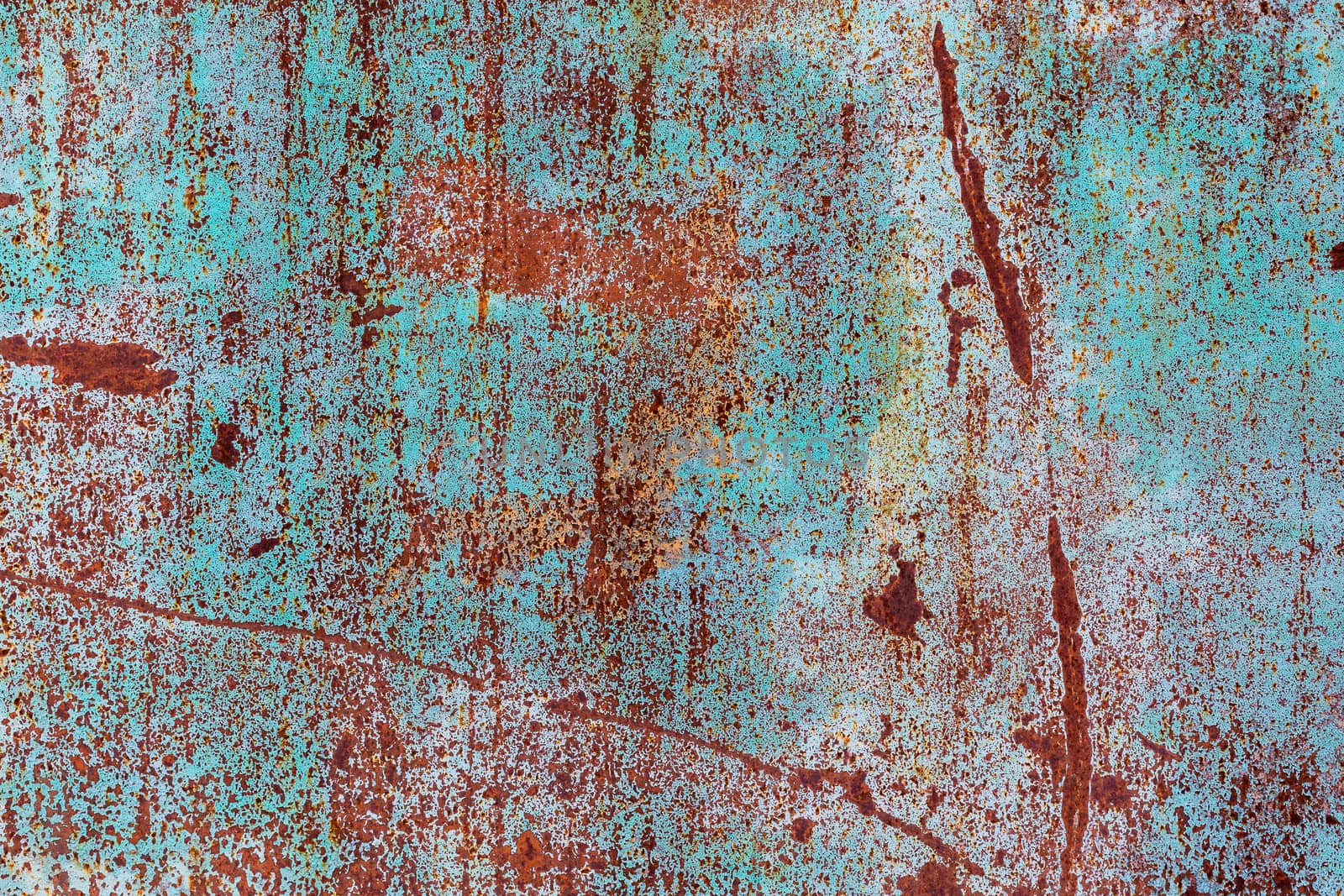 flat rusted metal sheet with peeling white and blue paint.