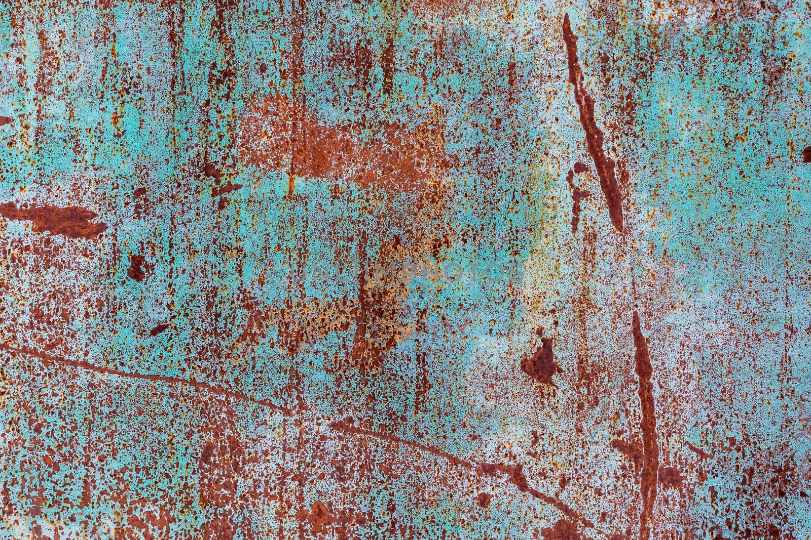 flat rusted metal sheet with peeling white and blue paint.