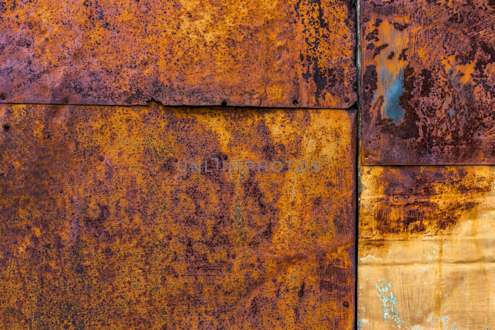 Several nailed rusted iron sheets flat background and texture