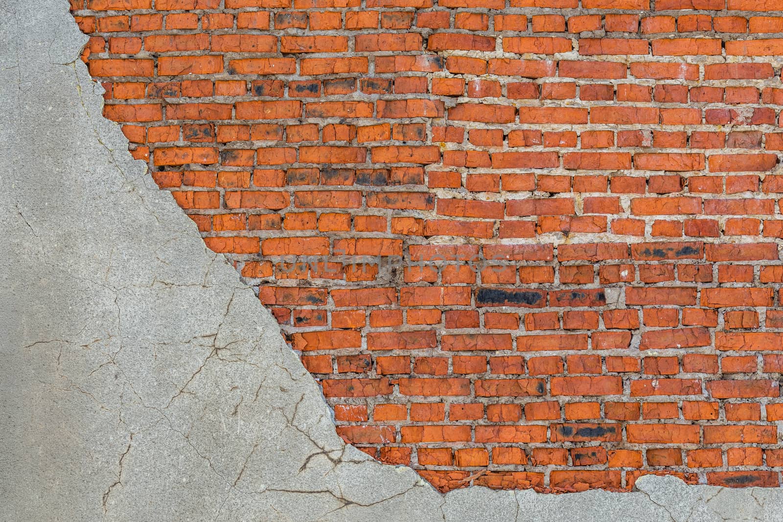 old bad brick wall with leftovers of gray peeled thick sandy plaster by z1b