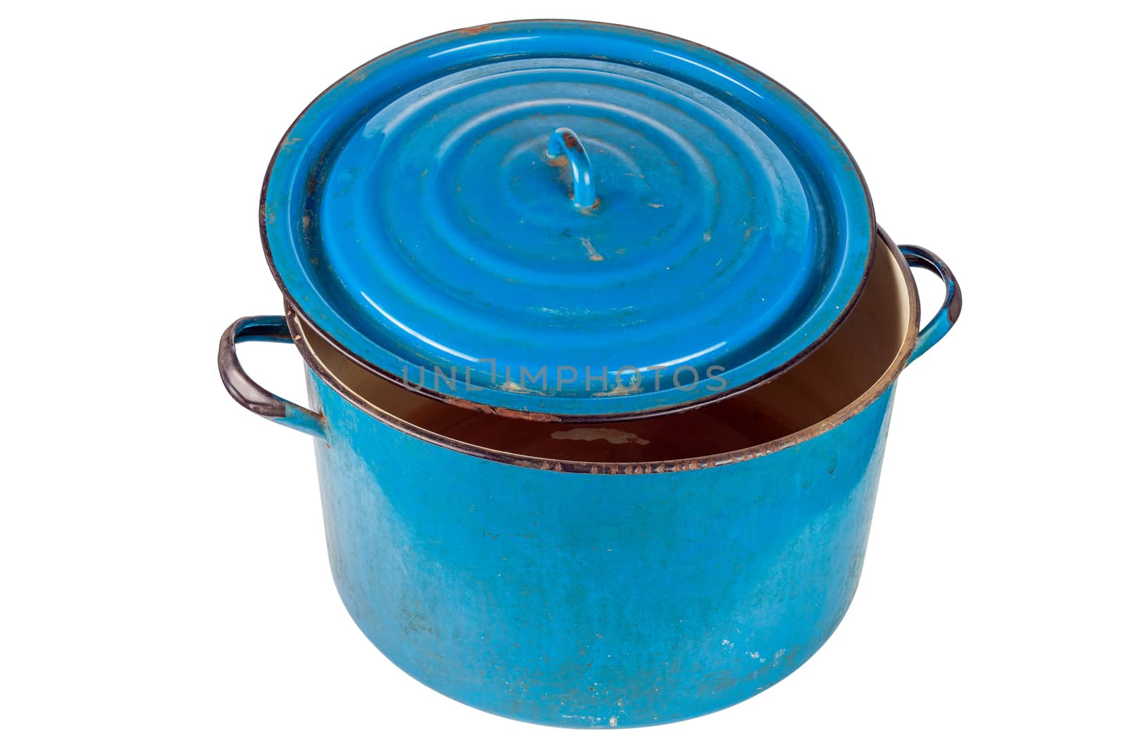 An old large ajar dirty enameled blue pot with cover isolated on white background. Used for heating water for washing in urban ghetto or in poor village. Fifty liters capacity.