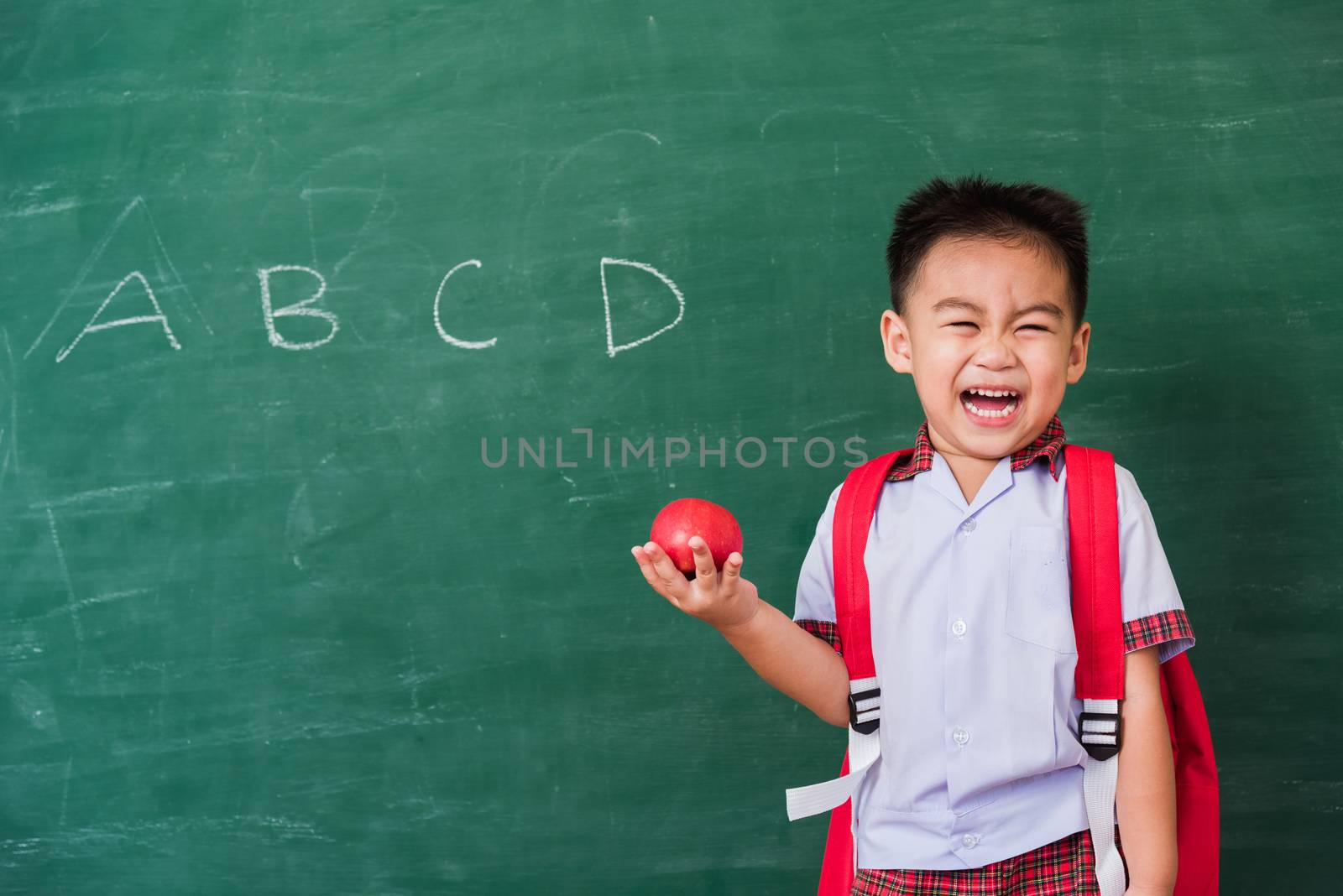 Child boy from kindergarten in student uniform with school bag h by Sorapop