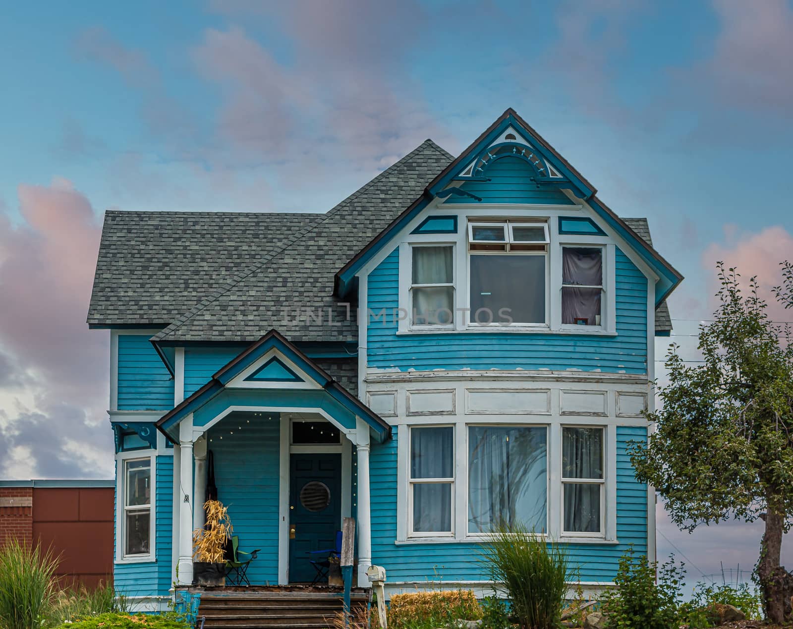 Blue Victorian on Hill at Dusk by dbvirago