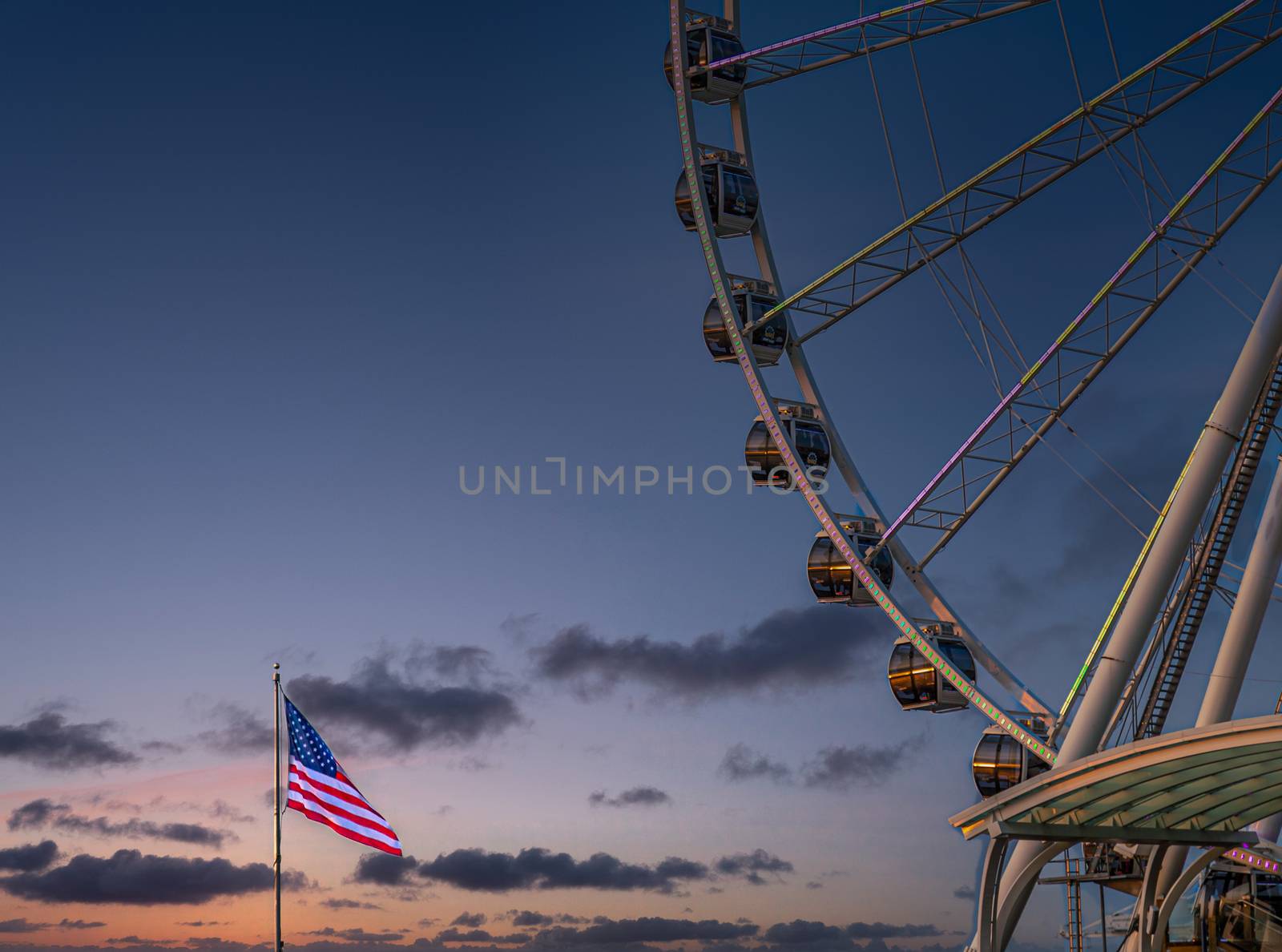 Great Wheel and Flag at Sunset by dbvirago