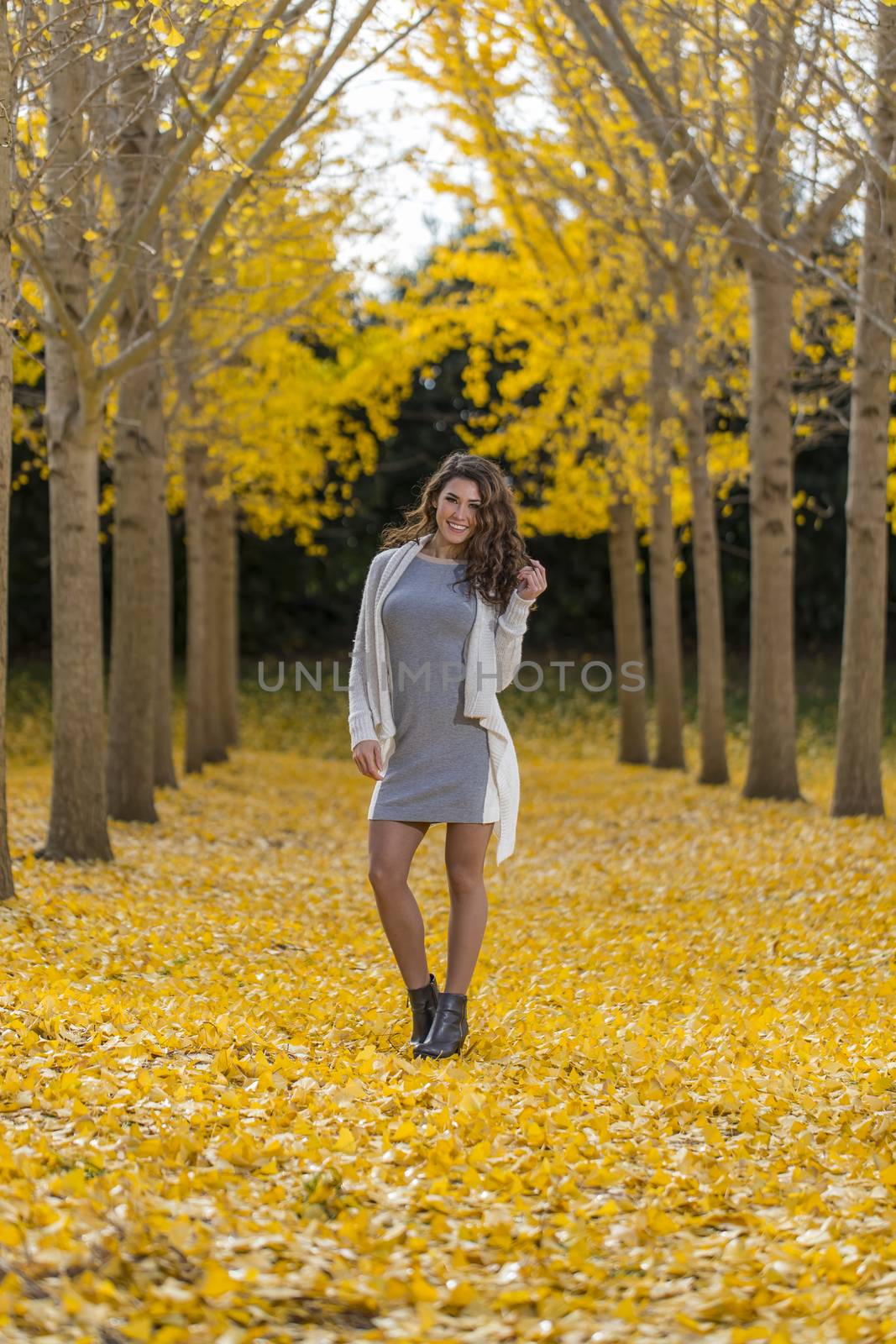 A beautiful brunette model with yellow fall foliage