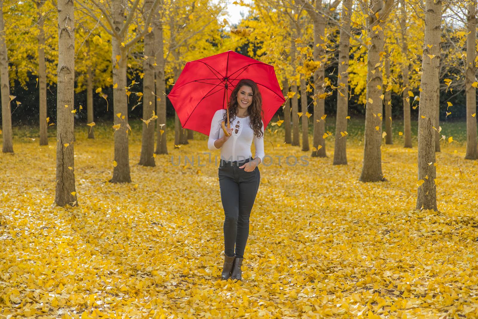 A beautiful brunette model with yellow fall foliage