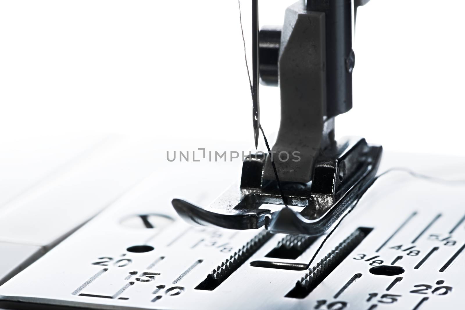 6 - Pure white plain background, dark silhouette of ready to go sewing machine, leading left to right with copy space.