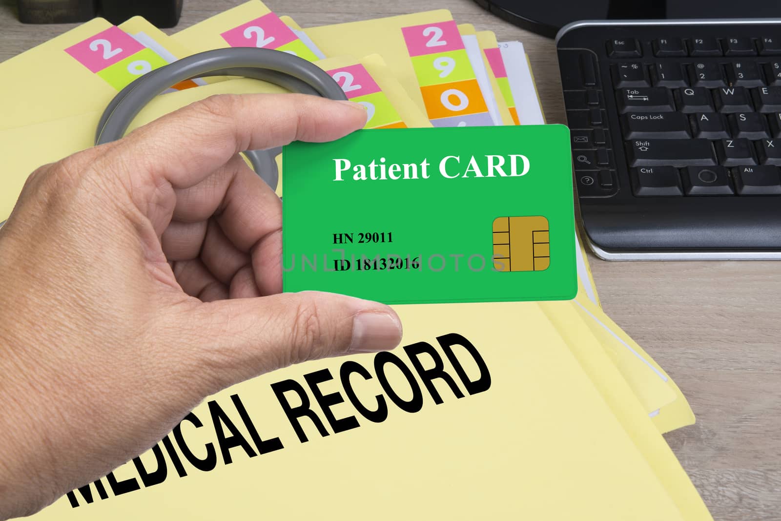 Someone hand holding patient smart card with medical record floder on background.