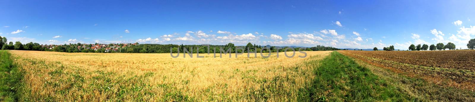 panoramic view over stubble field and acre in summer by Jochen