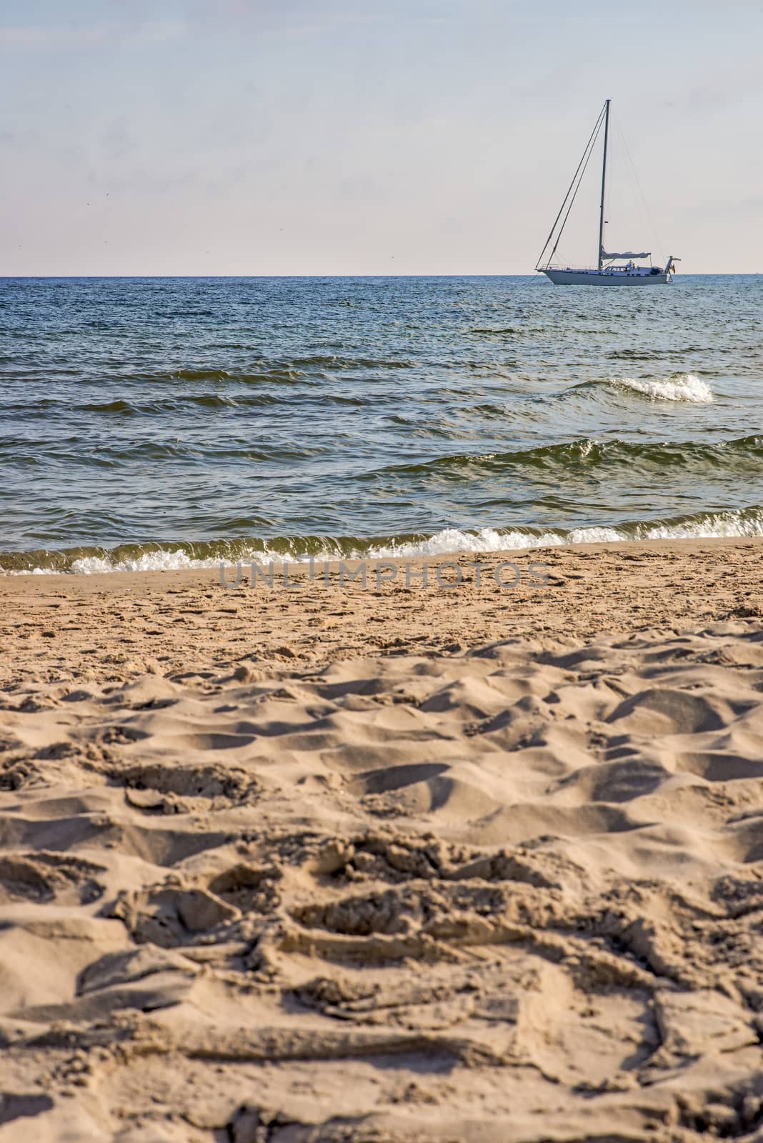Sailboat anchored on a beach in the Baltic Sea by Jochen