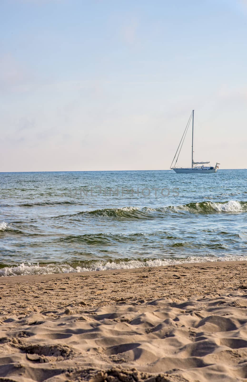 Sailboat anchored on a beach in the Baltic Sea by Jochen