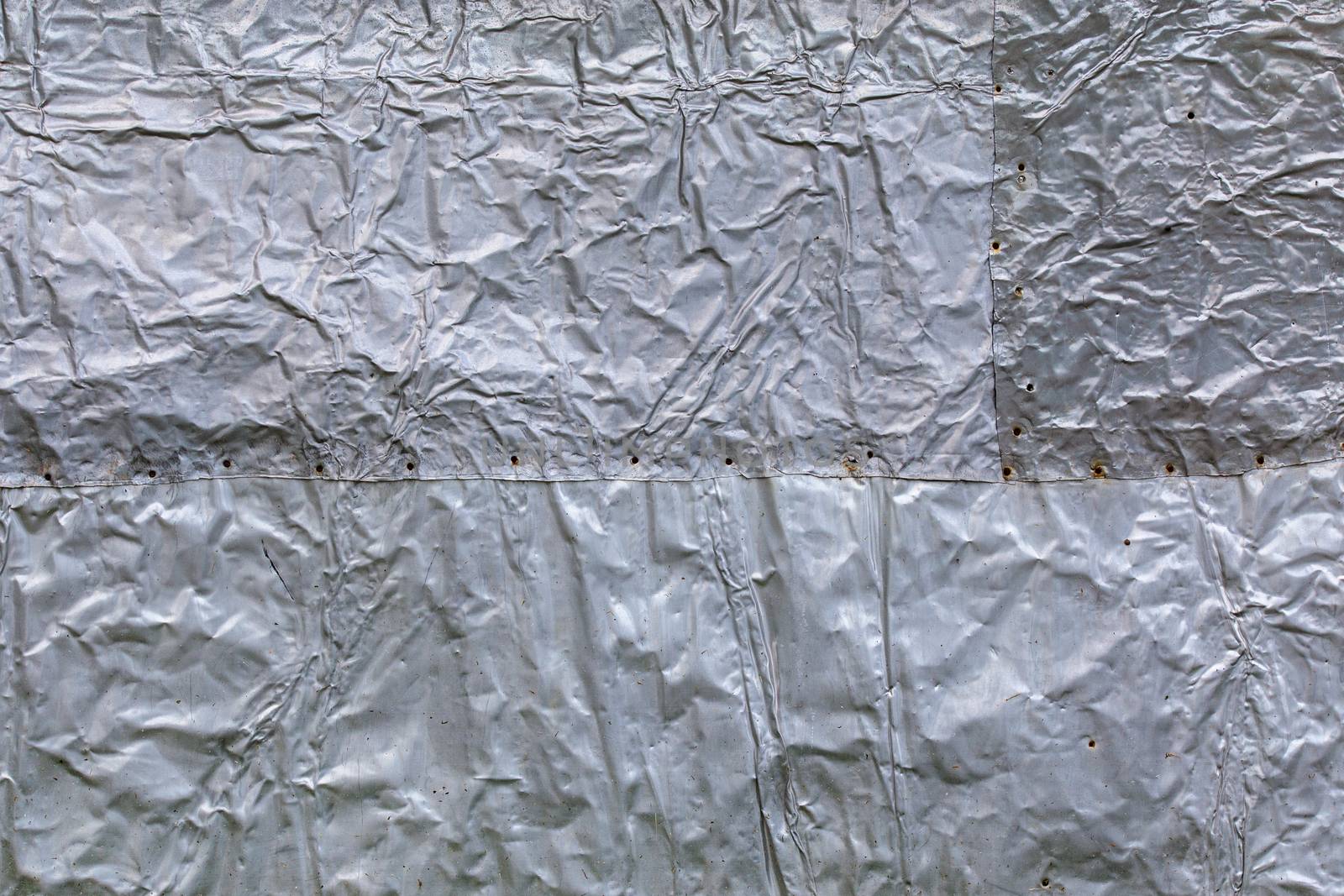 crumpled thick aluminium foil wall insulation surface texture and background.