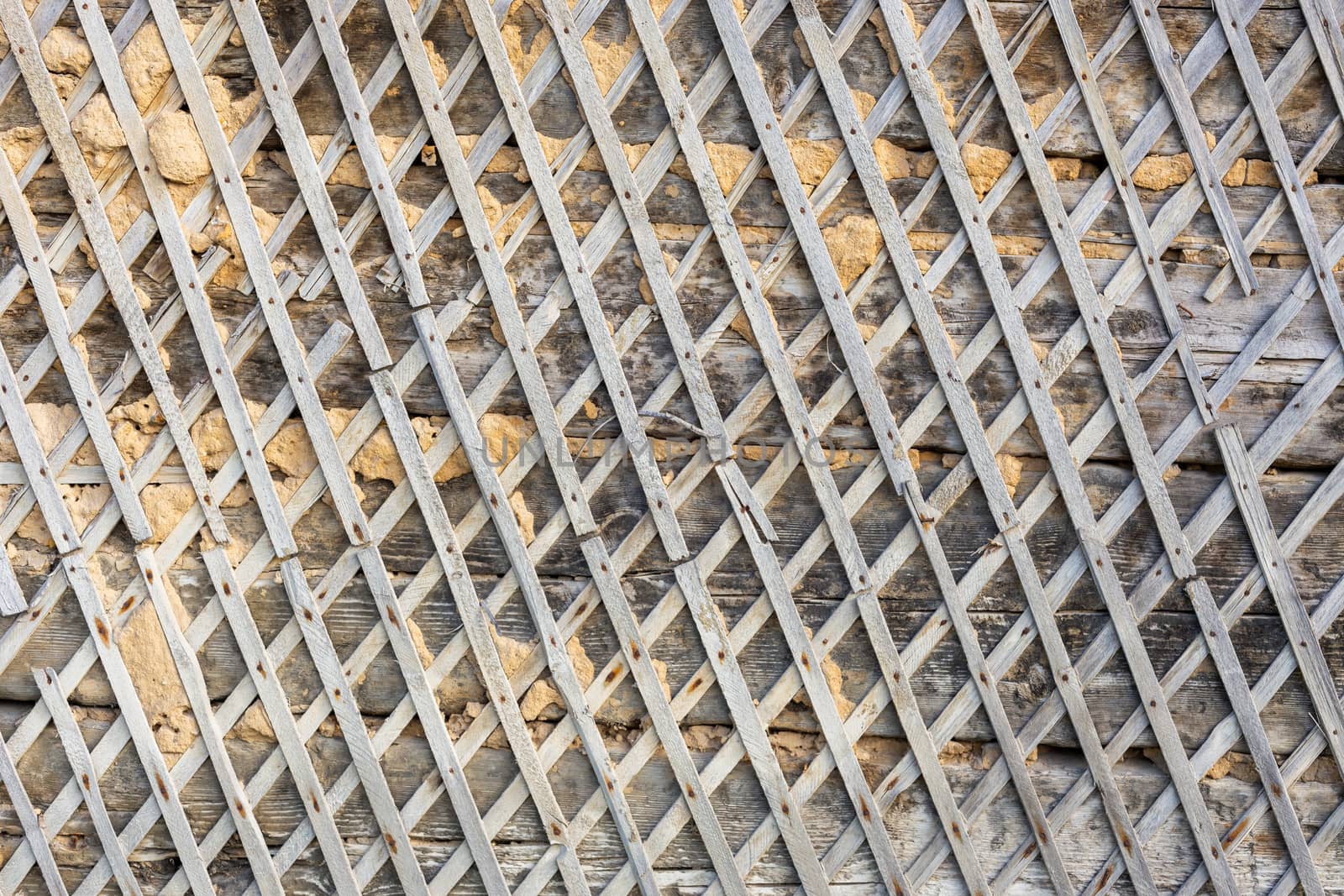 wattle and daub wall texture and background under direct sunlight at daytime.