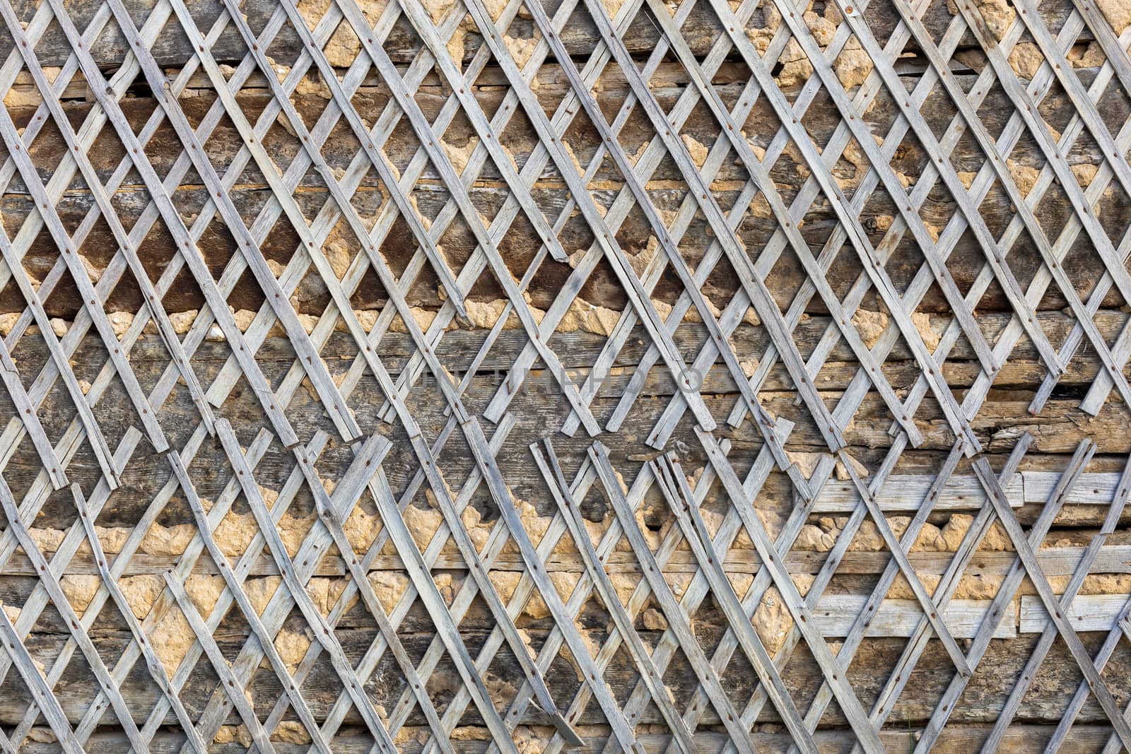 wattle and daub wall texture and background under direct sunlight at daytime.
