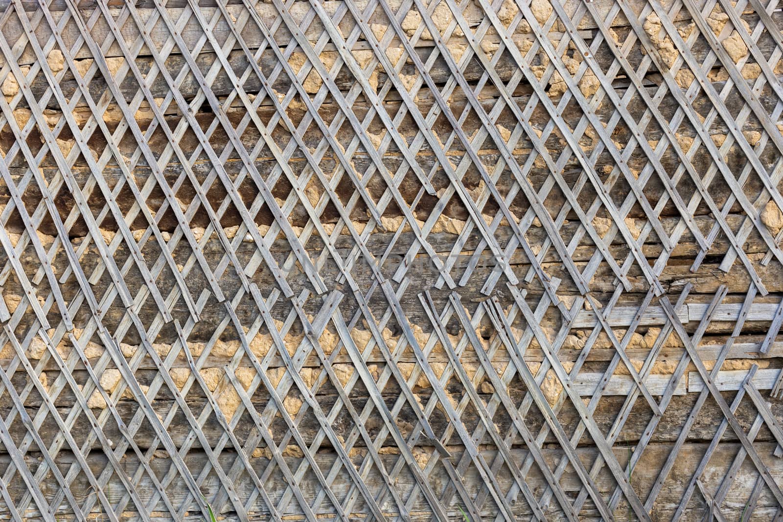 wattle and daub wall texture and background under direct sunlight at daytime.