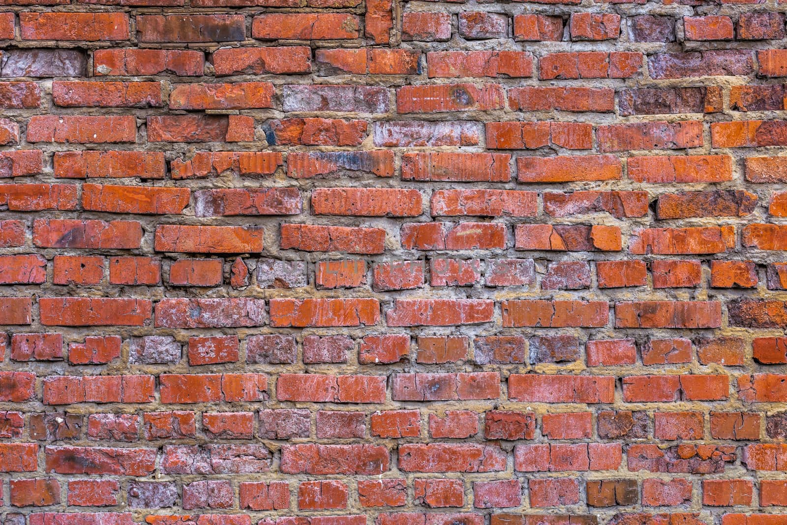 flat brick wall background and texture with light signs of erosion.