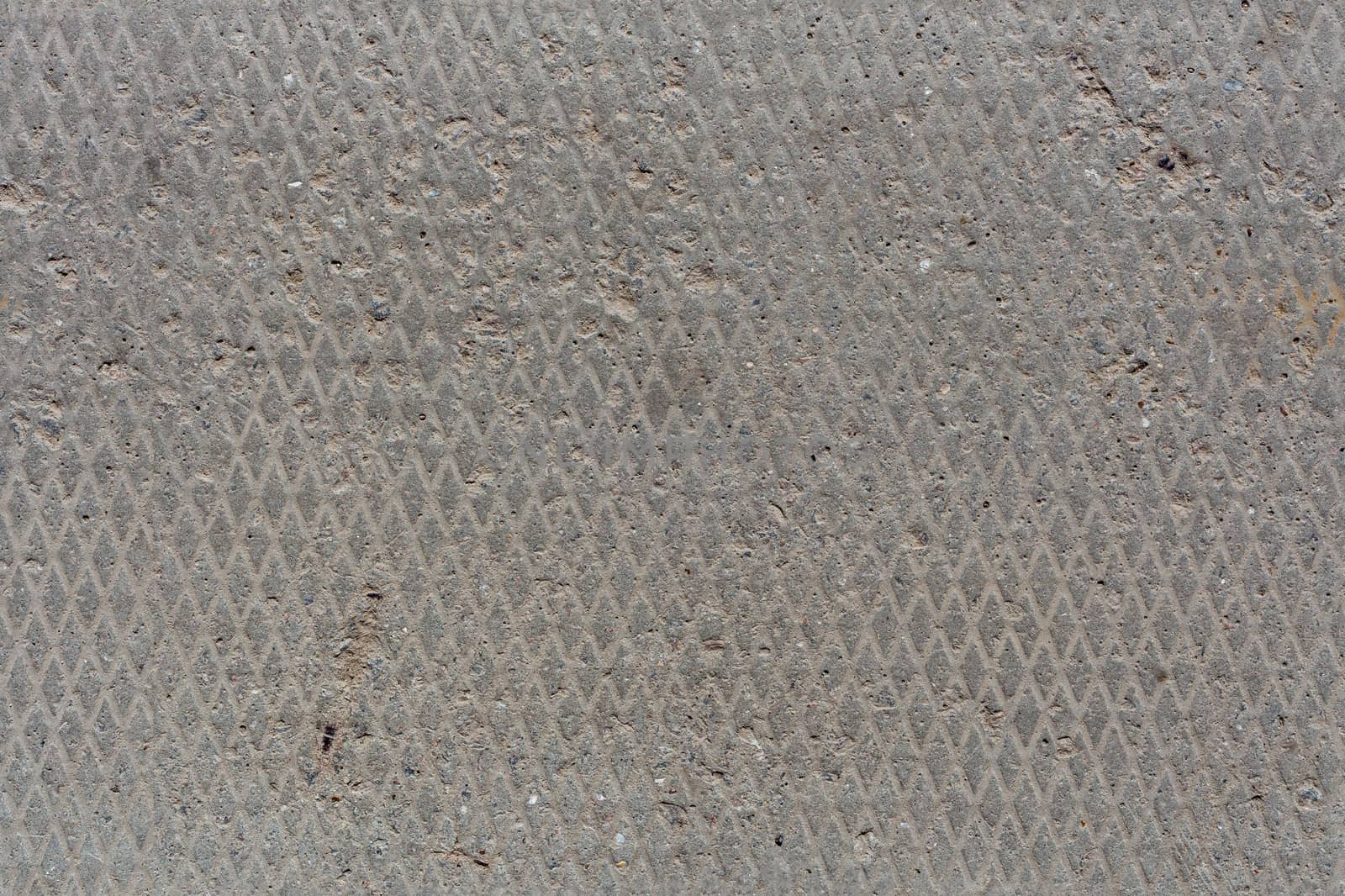 seamless old flat and dry concrete texture with diamond pattern and light signs of erosion.