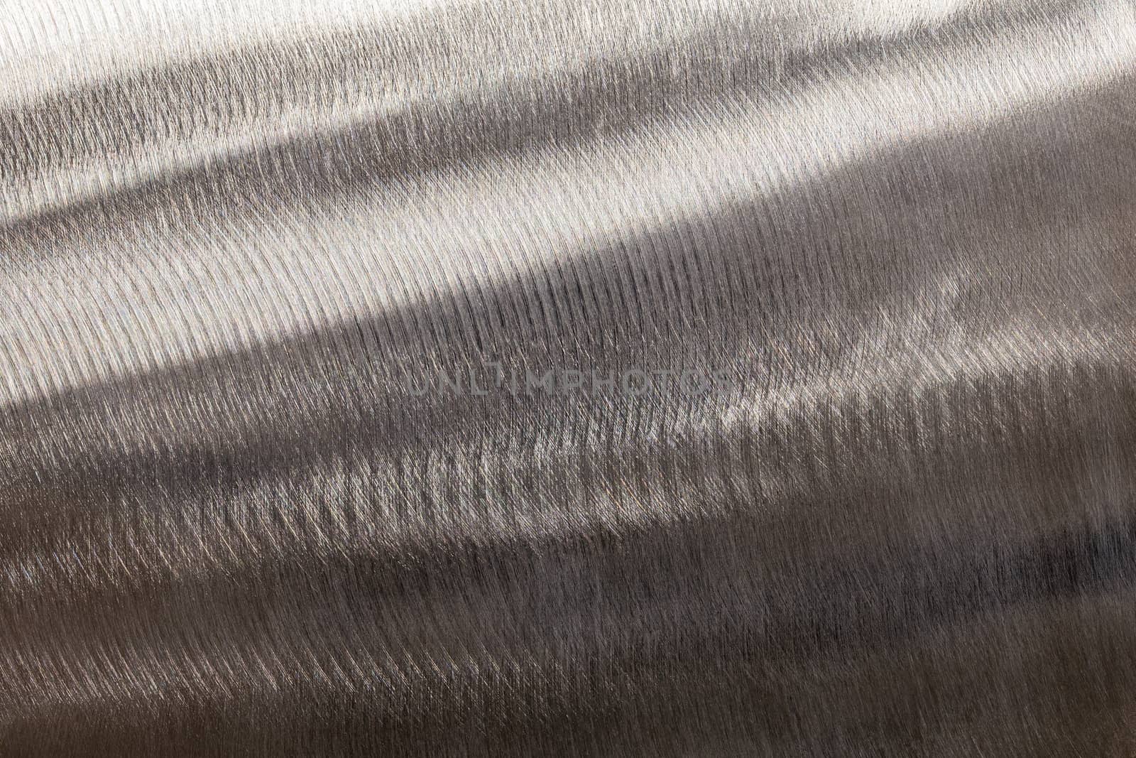 Close-up texture of flat steel surface manually cleaned with a flap wheel angle grinder. Surface prepaired before painting as part of the repair work.