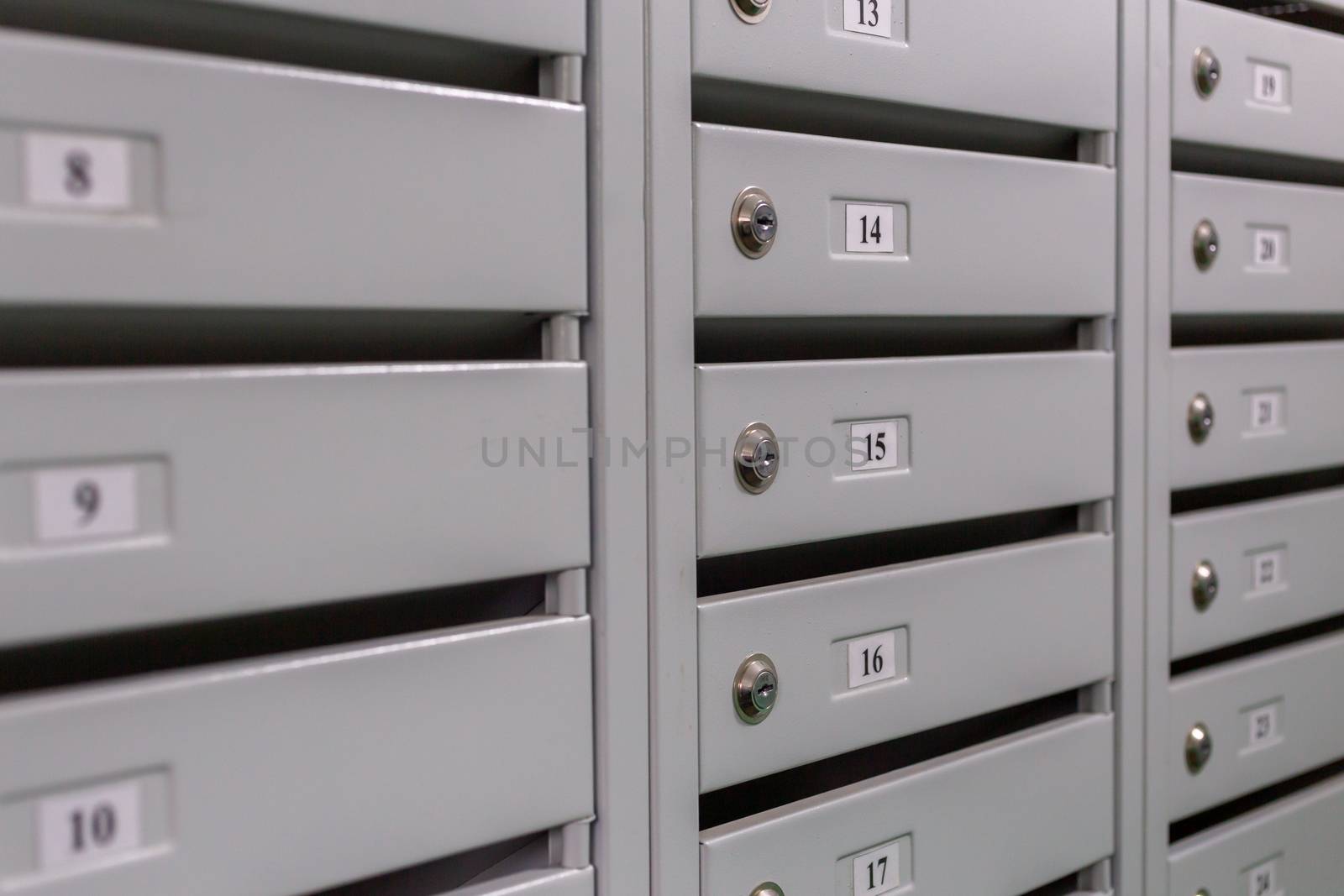 gray mailboxes on the landing of small russian condominium