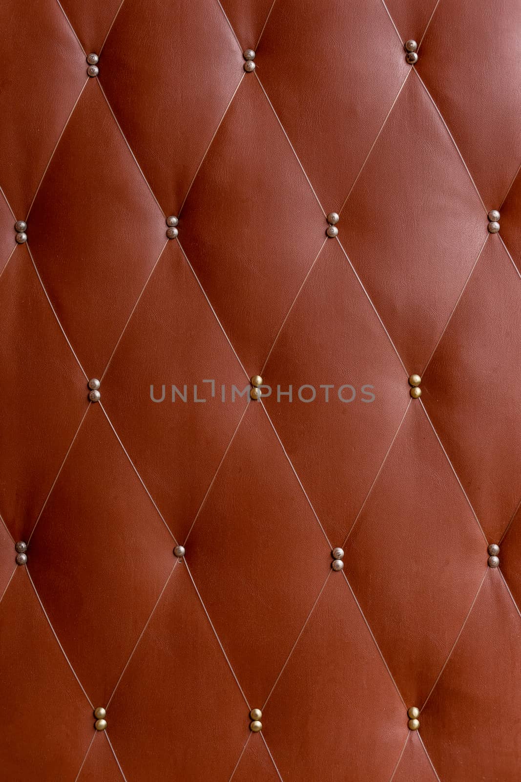 Soviet soft brown dermantine front door with a banner of fishing line and nails - full frame background and texture.