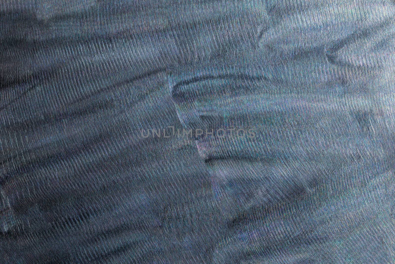 Close-up texture of flat steel surface manually cleaned with a flap wheel angle grinder. Surface prepaired before painting as part of the repair work.