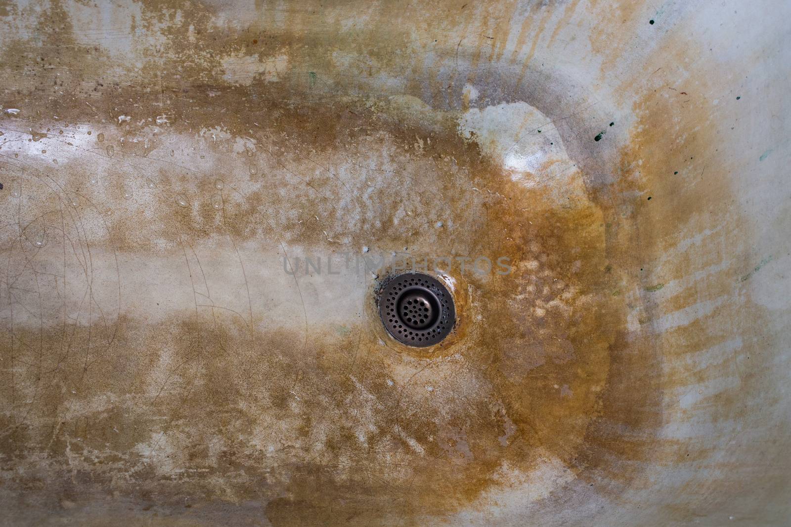 old rusted and stained cast iron bathtub close-up.
