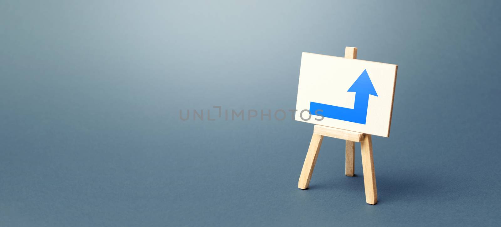 Easel with a blue right arrow. Direction to go around on the right. Advertising, indicating the location of the store object. Minimalism. Navigation, customer acquisition. Copy space