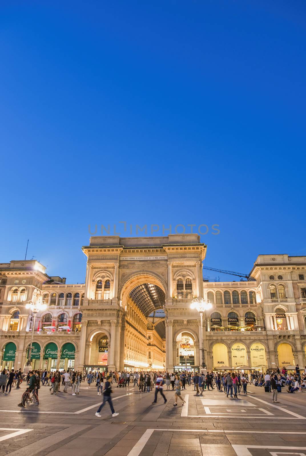 MILAN, ITALY - SEPTEMBER 2015: Tourists and locals enjoy night l by jovannig