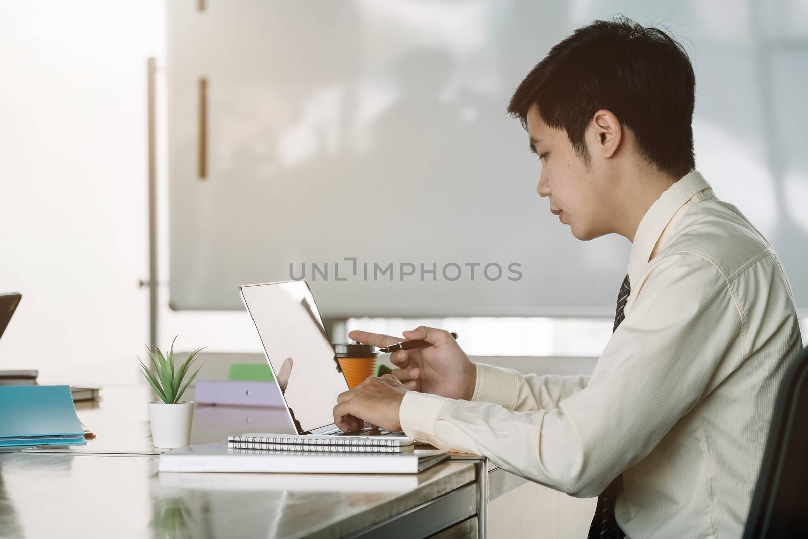 Businessman working with laptop computer at office.