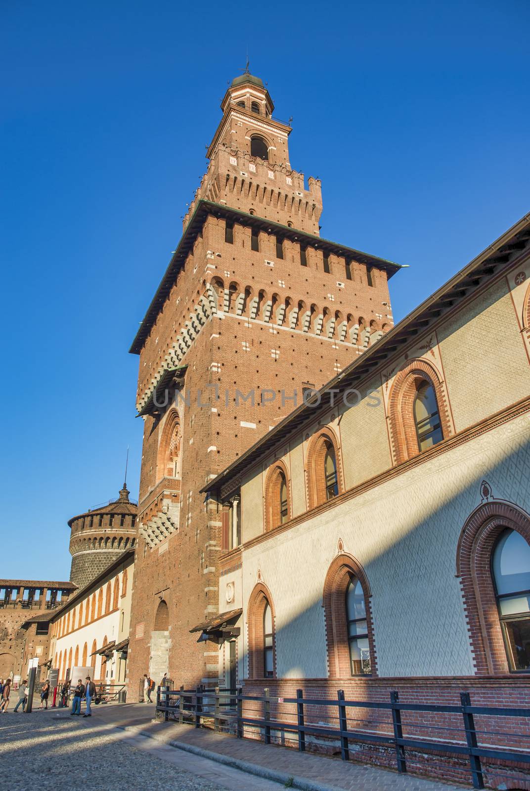 MILAN, ITALY - SEPTEMBER 2015: Tourists visit Sforza Castle and by jovannig