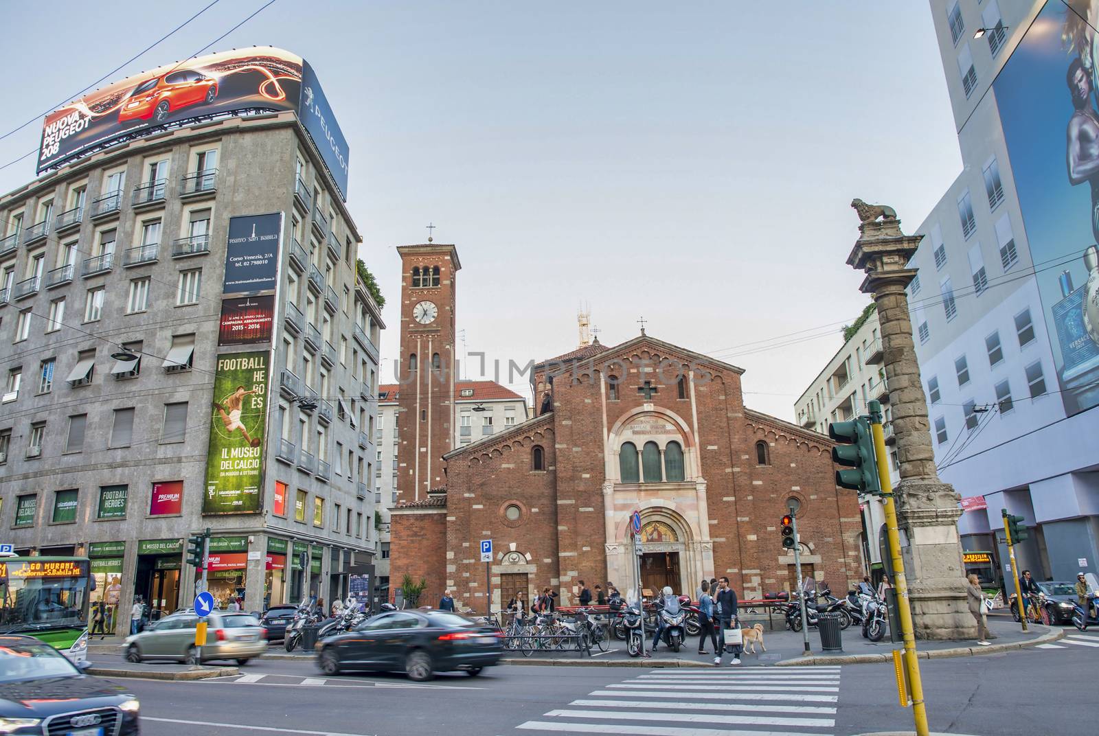 MILAN, ITALY - SEPTEMBER 2015: City buildings with advertisings at sunset.