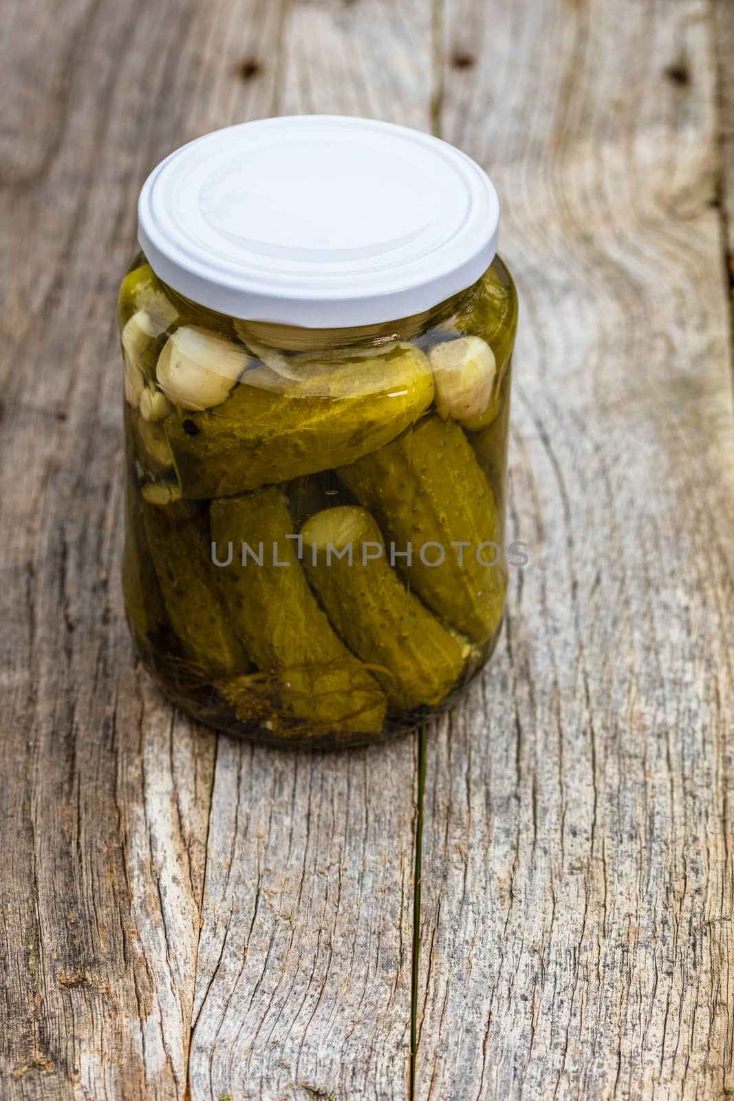 Close up of glass jar with pickles isolated. Preserved food conc by vladispas