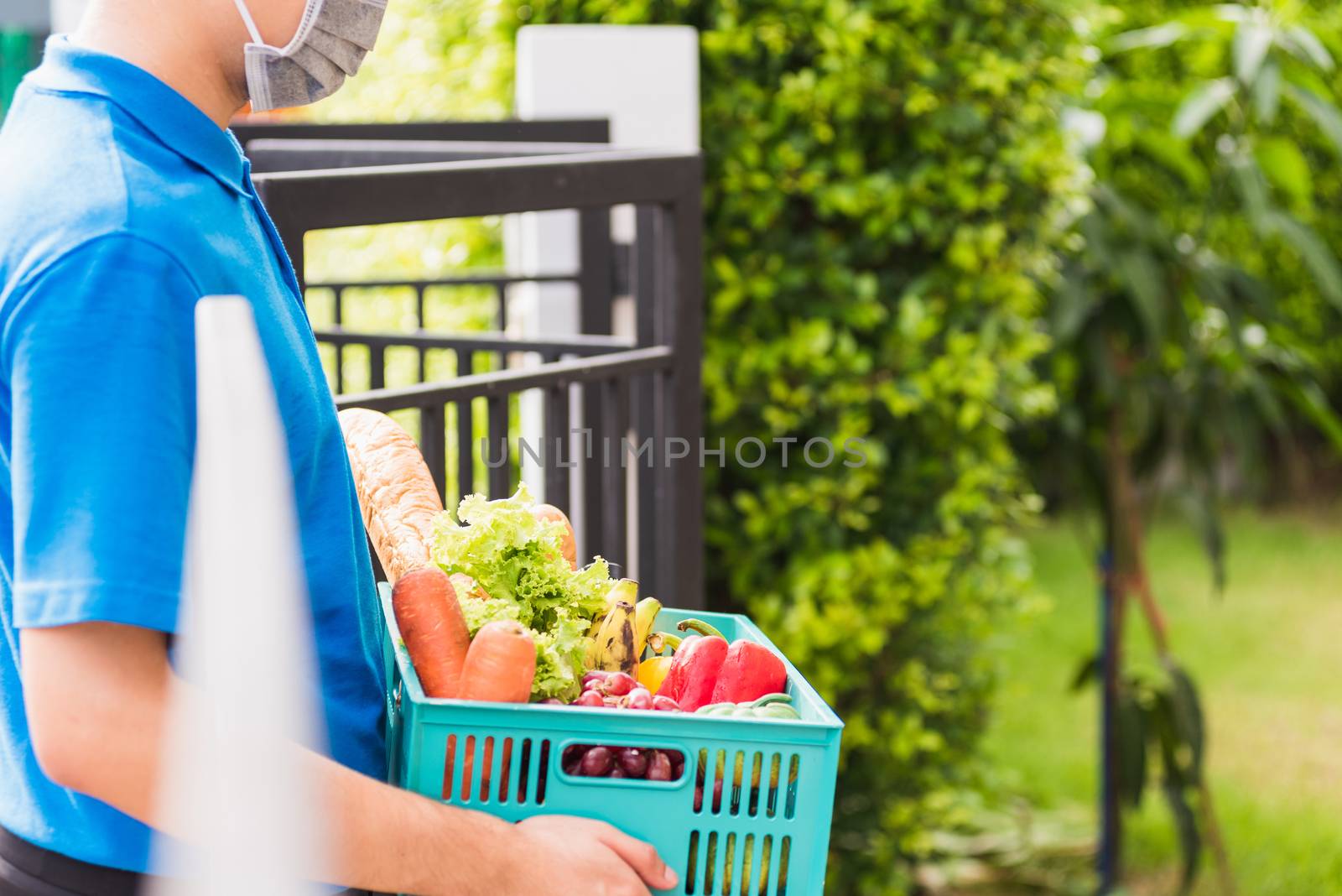 Delivery man wearing face mask protect he delivering fresh food  by Sorapop