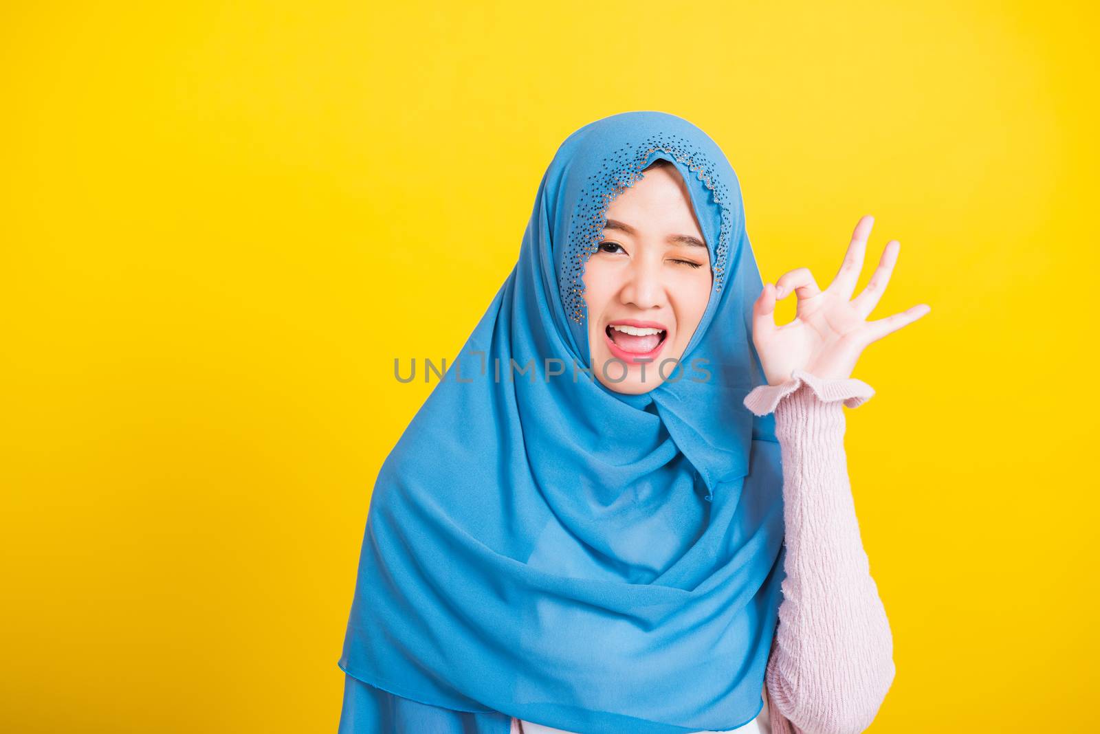 Asian Muslim Arab woman Islam wear hijab smile she showing gestu by Sorapop