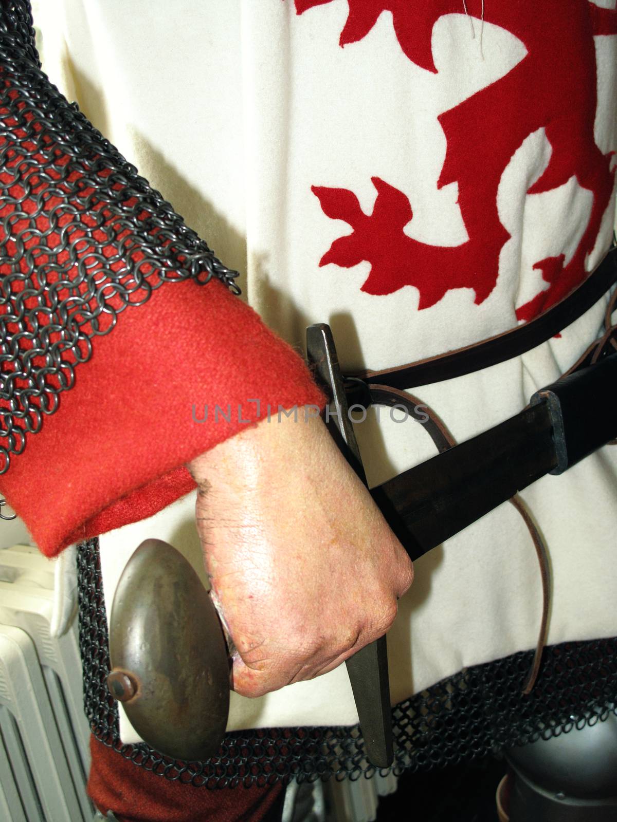 Manikin of a crusader medieval knight in chain mail armour bearing the heraldic lion rampant the royal standard of the king of England stock photo