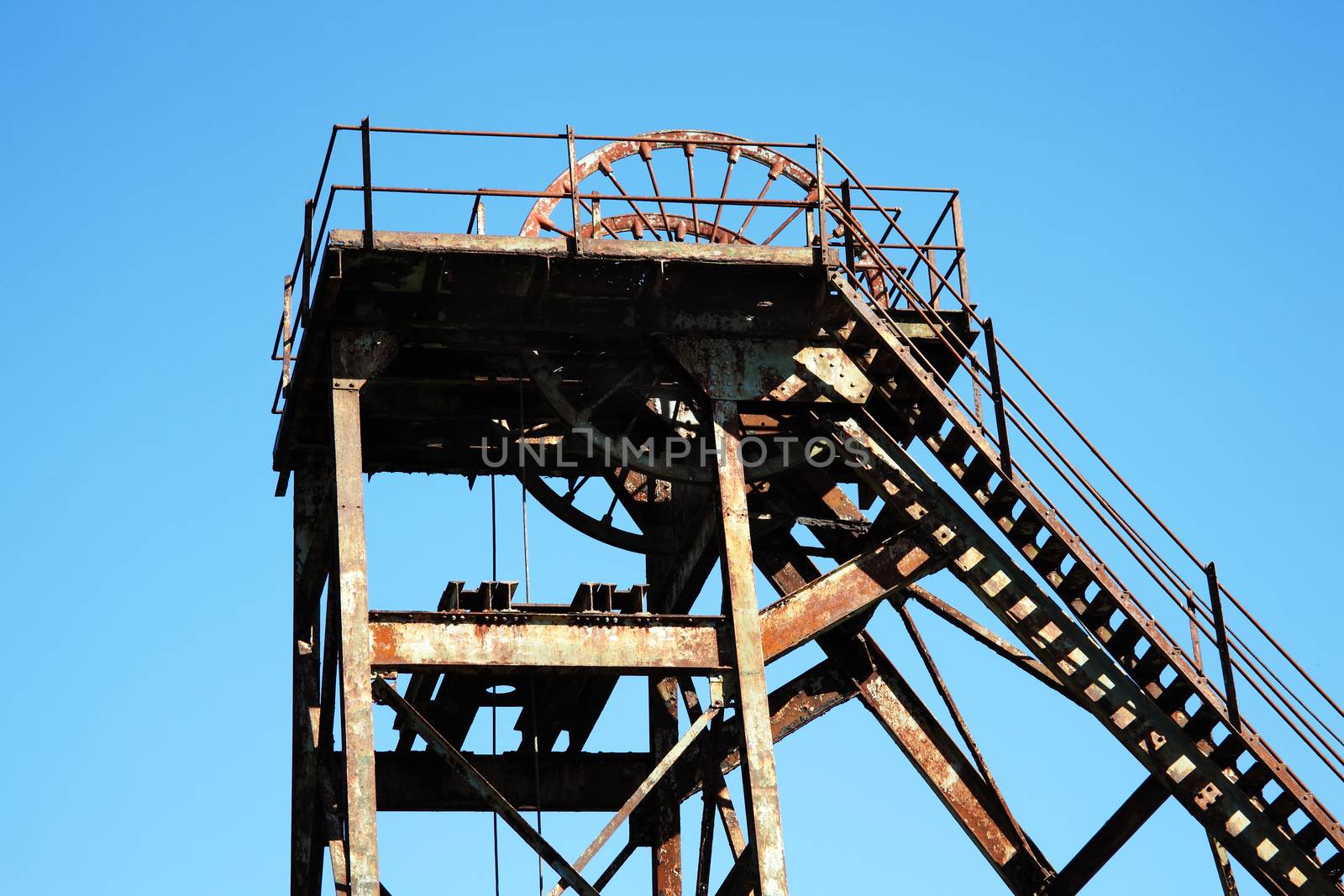 Hoist wheel which was used at a redundent coal mine shaft before energy mining came to an end due to environment global warming concerns stock photo