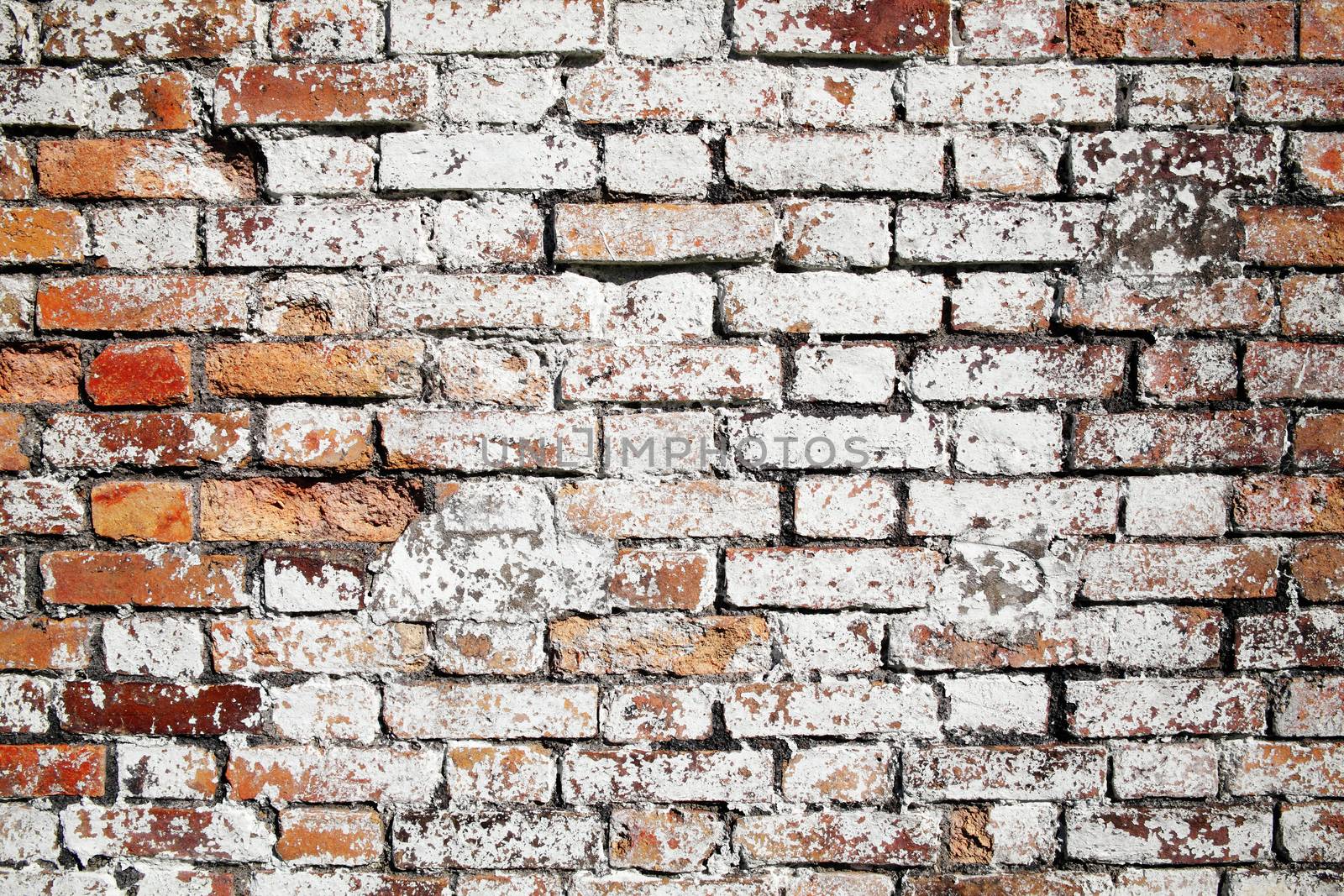 Old large red brick wall texture background distressed with white paint stock photo