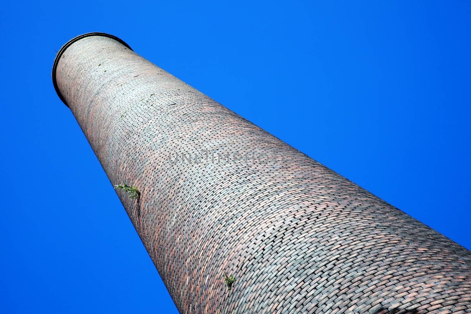 Old  obsolete smoke stack industrial chimney from the manufacturing Industrial Revolution stock photo