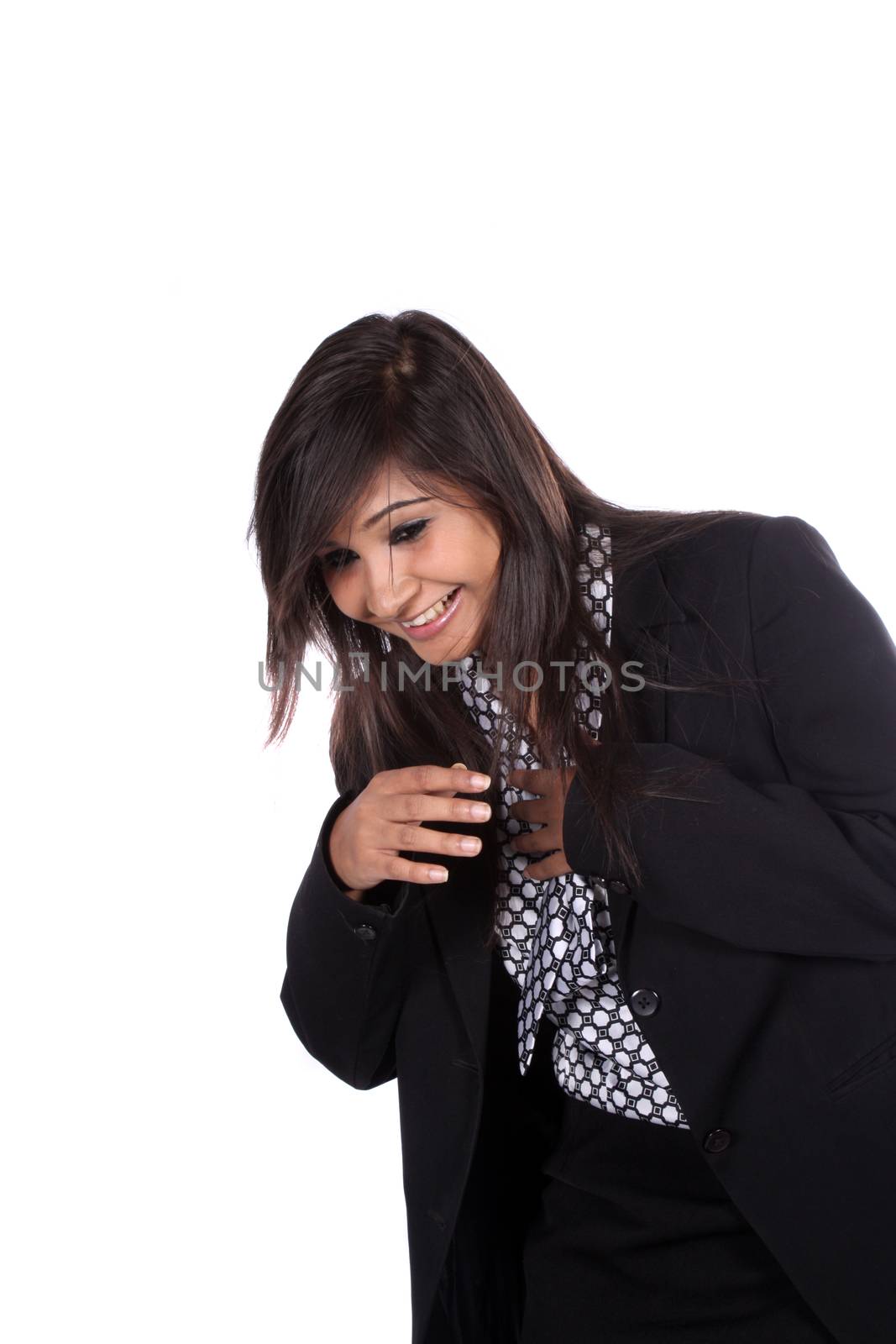 A beautiful young Indian businesswoman laughing, on white studio background.