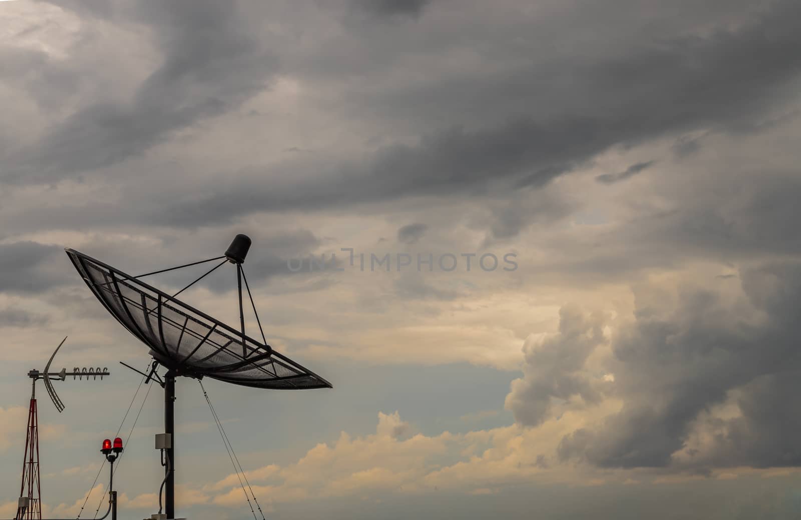 Black Satellite Dish Antenna Receiver Against on Blue Sky background for Communication and Media Industry, Symbolizing Global Communications. Free copy space for text, Selective focus.