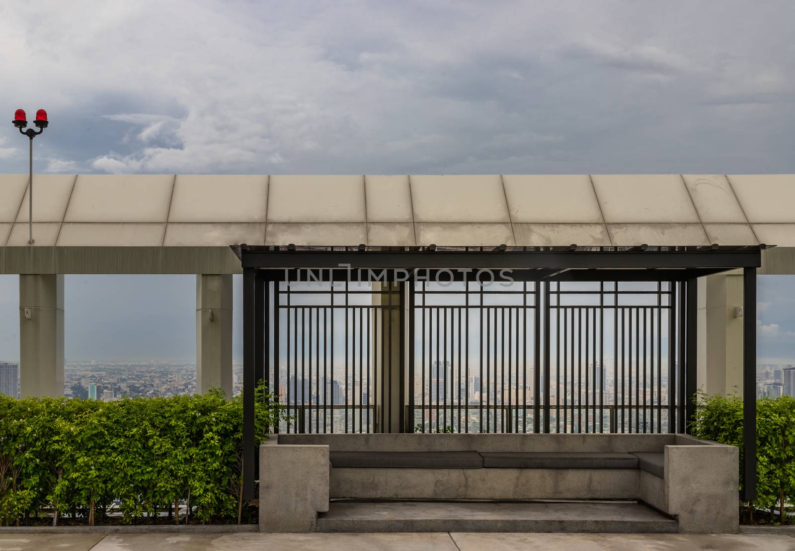 Relaxing furnished area on rooftop in warm summer day with the background of blue sky. Resting area.