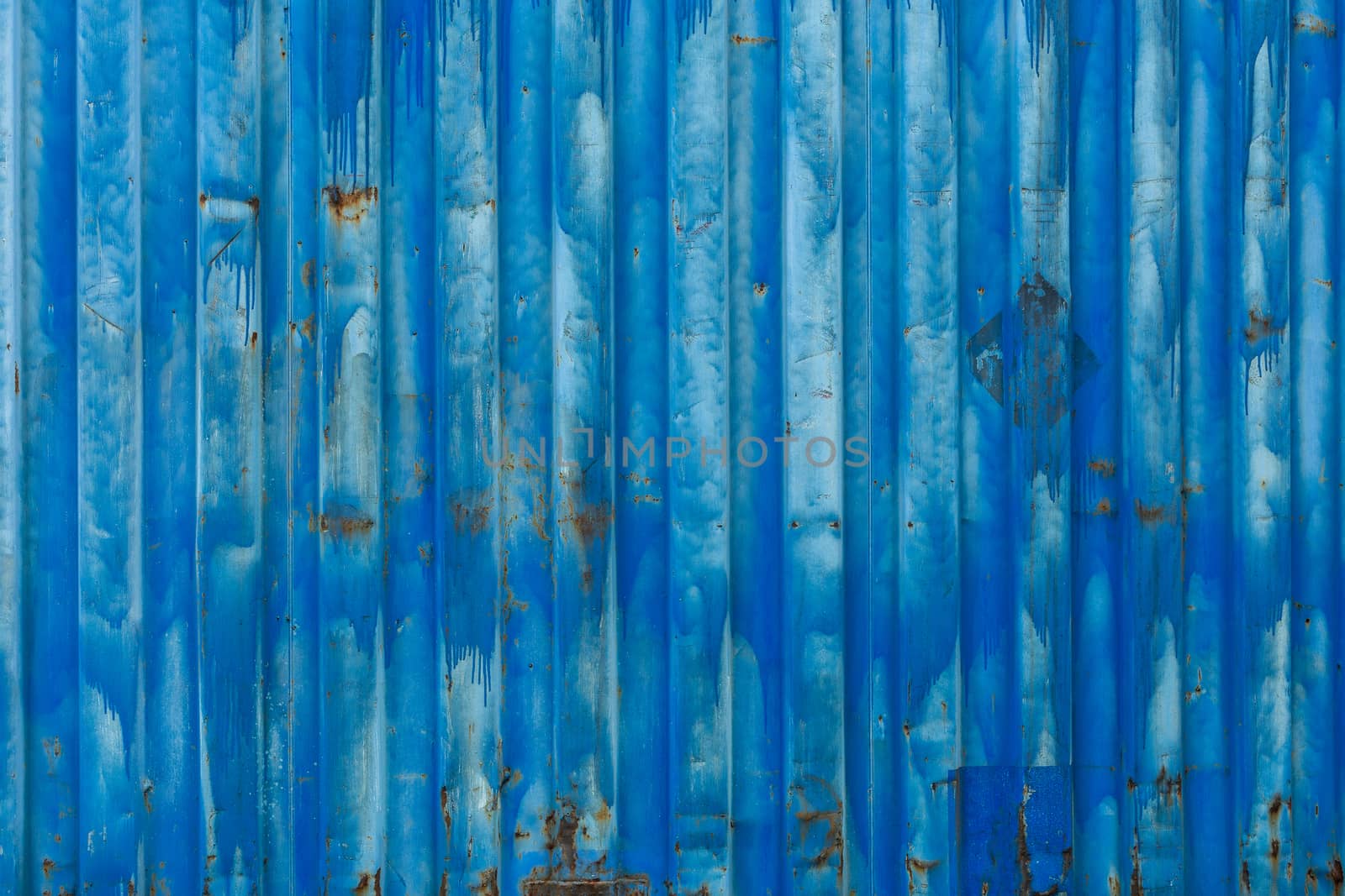 outside wall of old blue iso freight container - background and texture.
